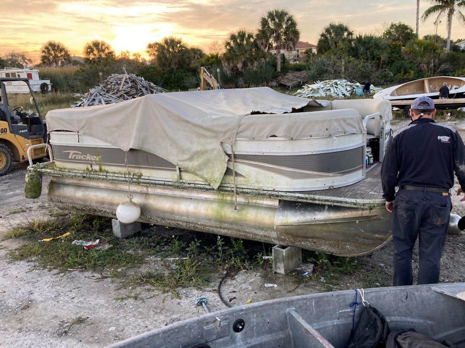 Sunken boat recovery in Northdale, FL: at the recycling yard 22 ft Sun Tracker Party Barge 22 from Northdale, FL at the recycling yard after the recovery