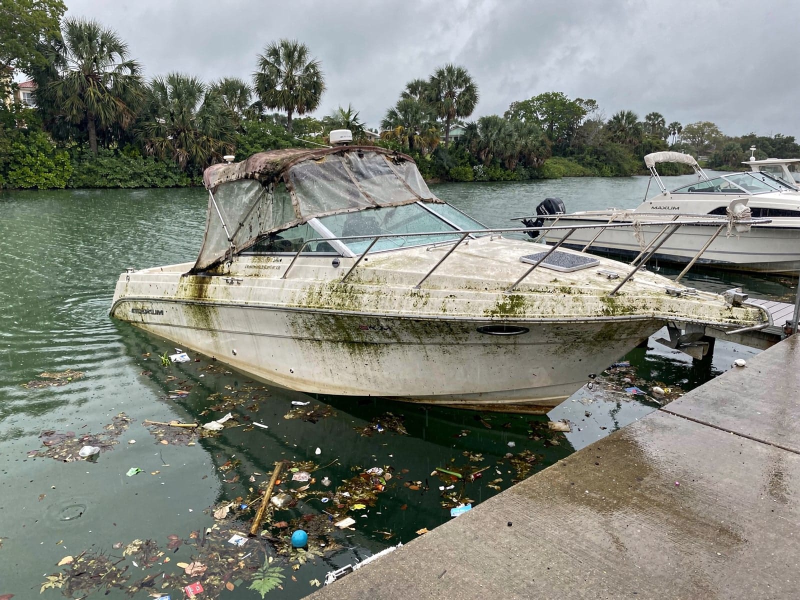 Sunken boat recovery in Palm Bay, FL: before Sunken 24 ft Maxum 2400 SCR by a boat ramp in Palm Bay, FL