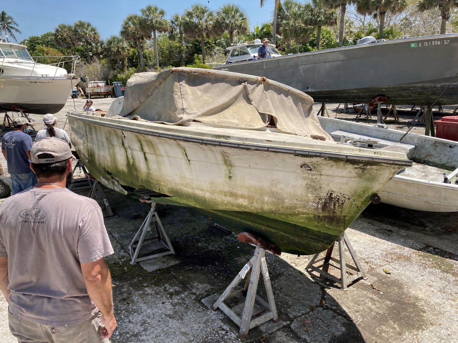 Sunken boat recovery in Palm City, FL: at the repair yard 23 ft Chris-Craft Cavalier from Palm City, FL on stands at a repair yard after the recovery