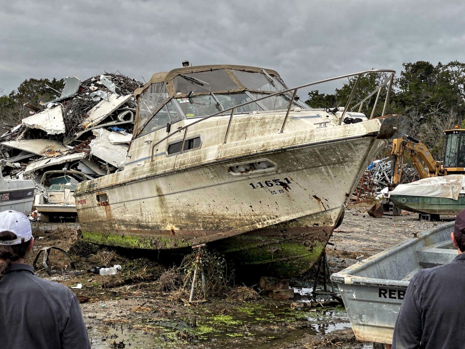 Sunken boat recovery in Palm Springs, FL: at the recycling yard 24 ft Bayliner 2455 Ciera from Palm Springs, FL at the recycling yard after the recovery