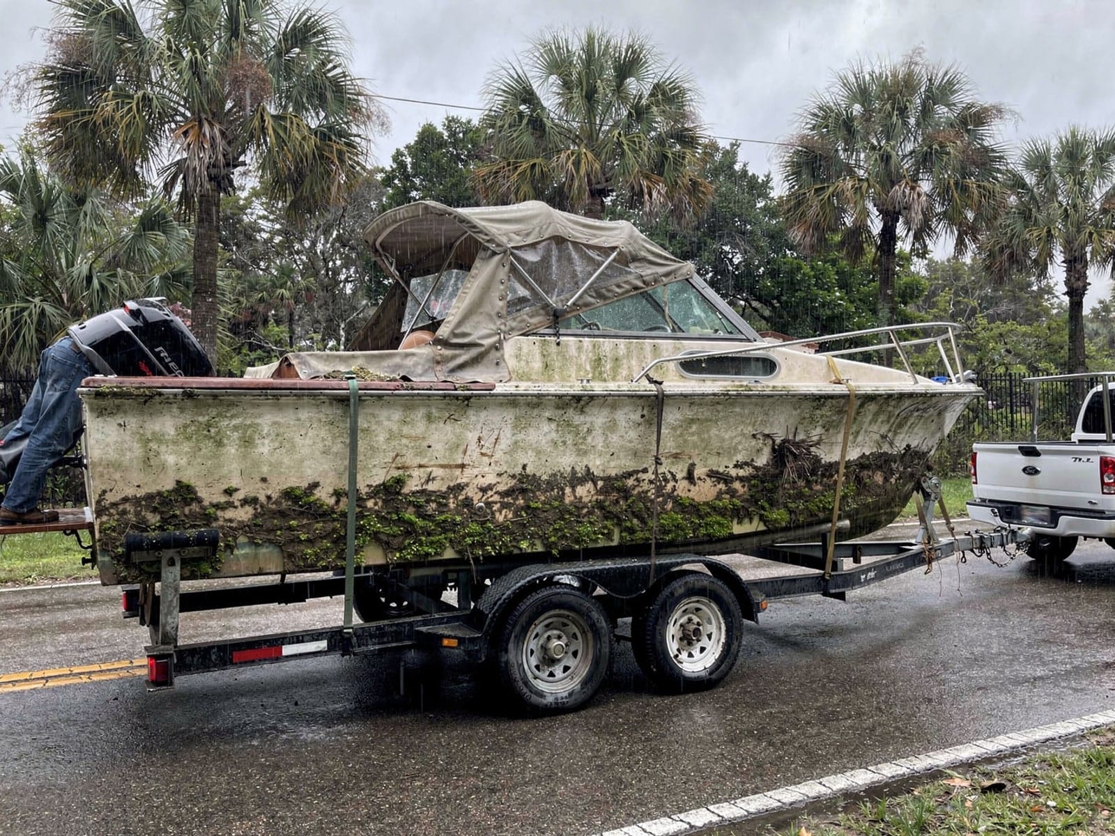 Sunken boat recovery in Palmetto Bay, FL: hauled out on a trailer 23 ft Chris-Craft Cavalier hauled out of Palmetto Bay, FL on a trailer after the recovery