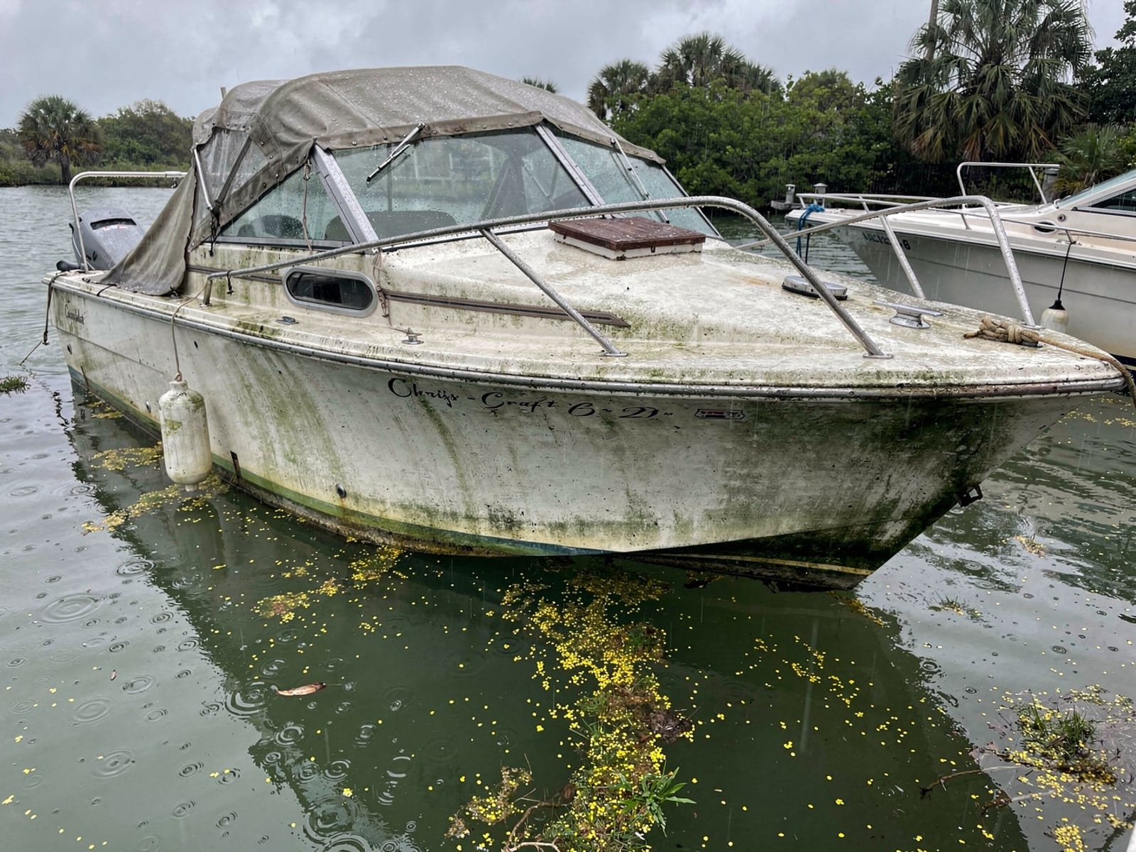 Sunken boat recovery in Palmetto Bay, FL: before Sunken 23 ft Chris-Craft Cavalier at its mooring in Palmetto Bay, FL