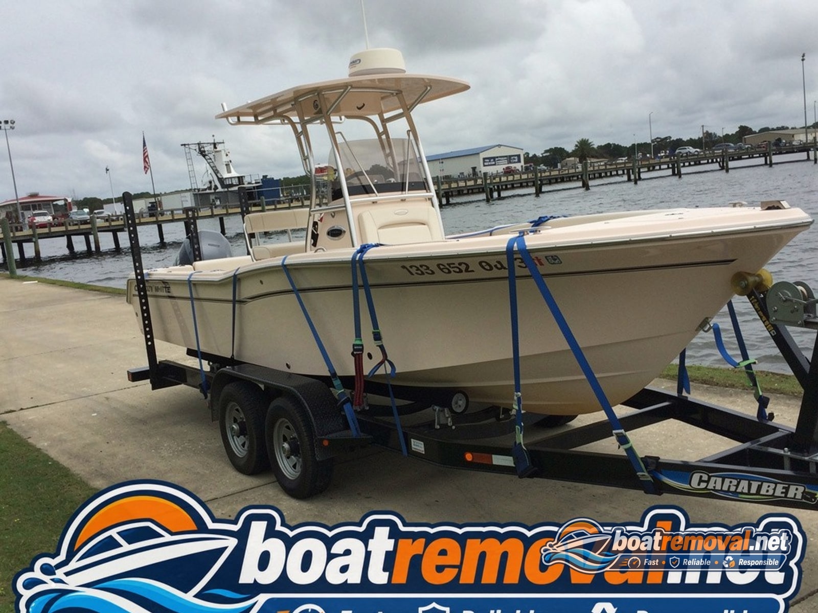 Pascagoula, MS: 23-foot Grady-White center console loaded for removal Same Grady-White pumped out and loaded on a trailer for removal after the storm