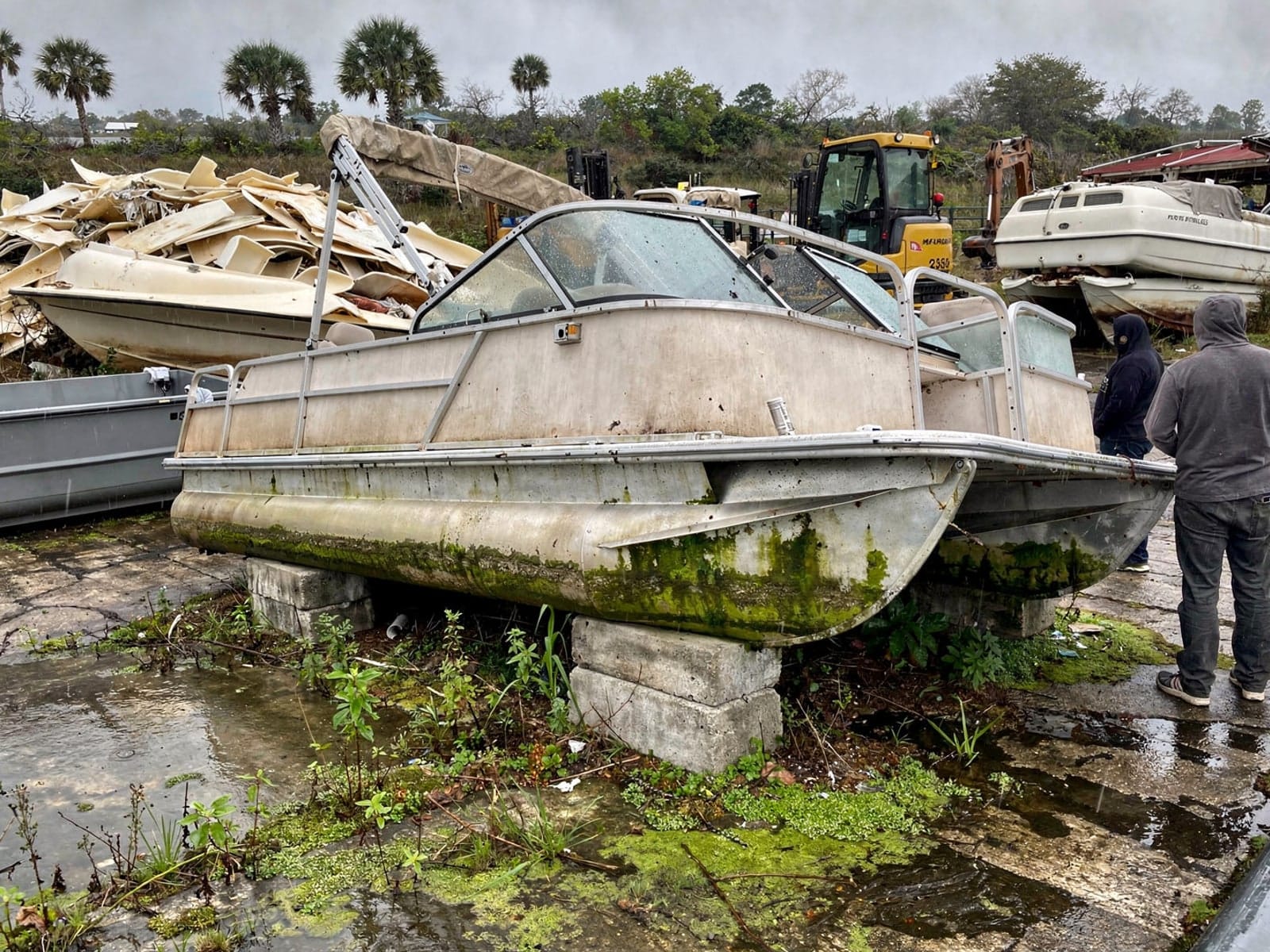 Sunken boat recovery in Port Charlotte, FL: at the recycling yard 24 ft Harris FloteBote 24 from Port Charlotte, FL at the recycling yard after the recovery