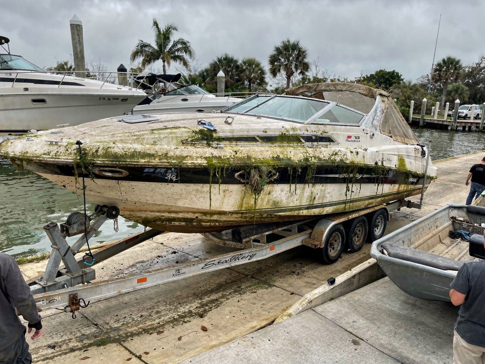 Sunken boat recovery in Port St John, FL: pulled out at the ramp 26 ft Sea Ray 268 Sundancer pulled out on a trailer at a Port St John, FL boat ramp