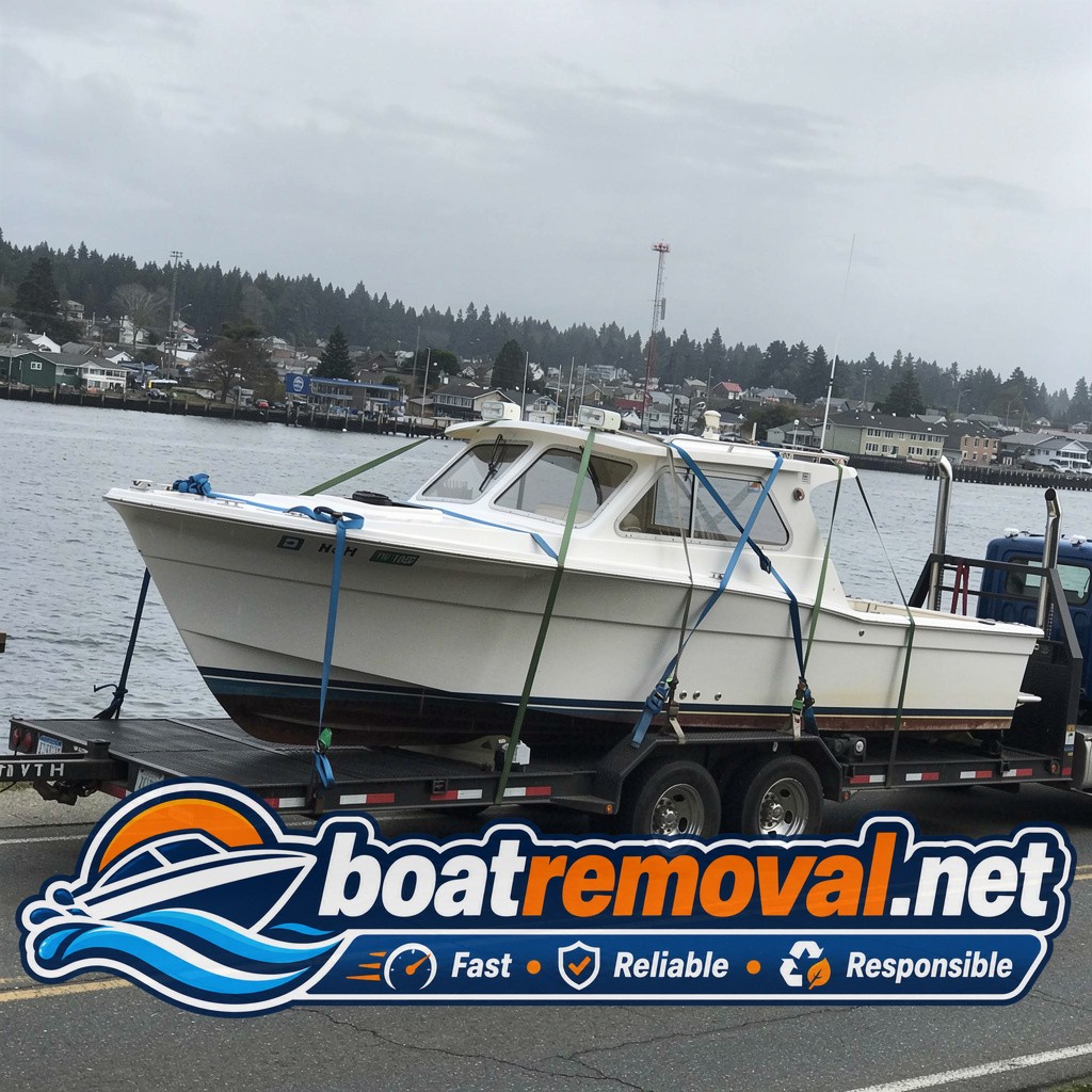 Same sportfishing boat hull loaded onto a barge after being raised from shallow water