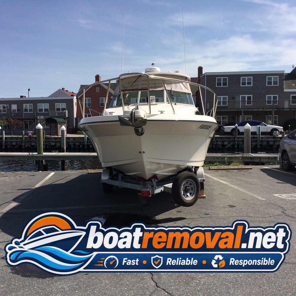 Formula cruiser loaded onto a trailer after removal from a marina slip in Portland, Maine