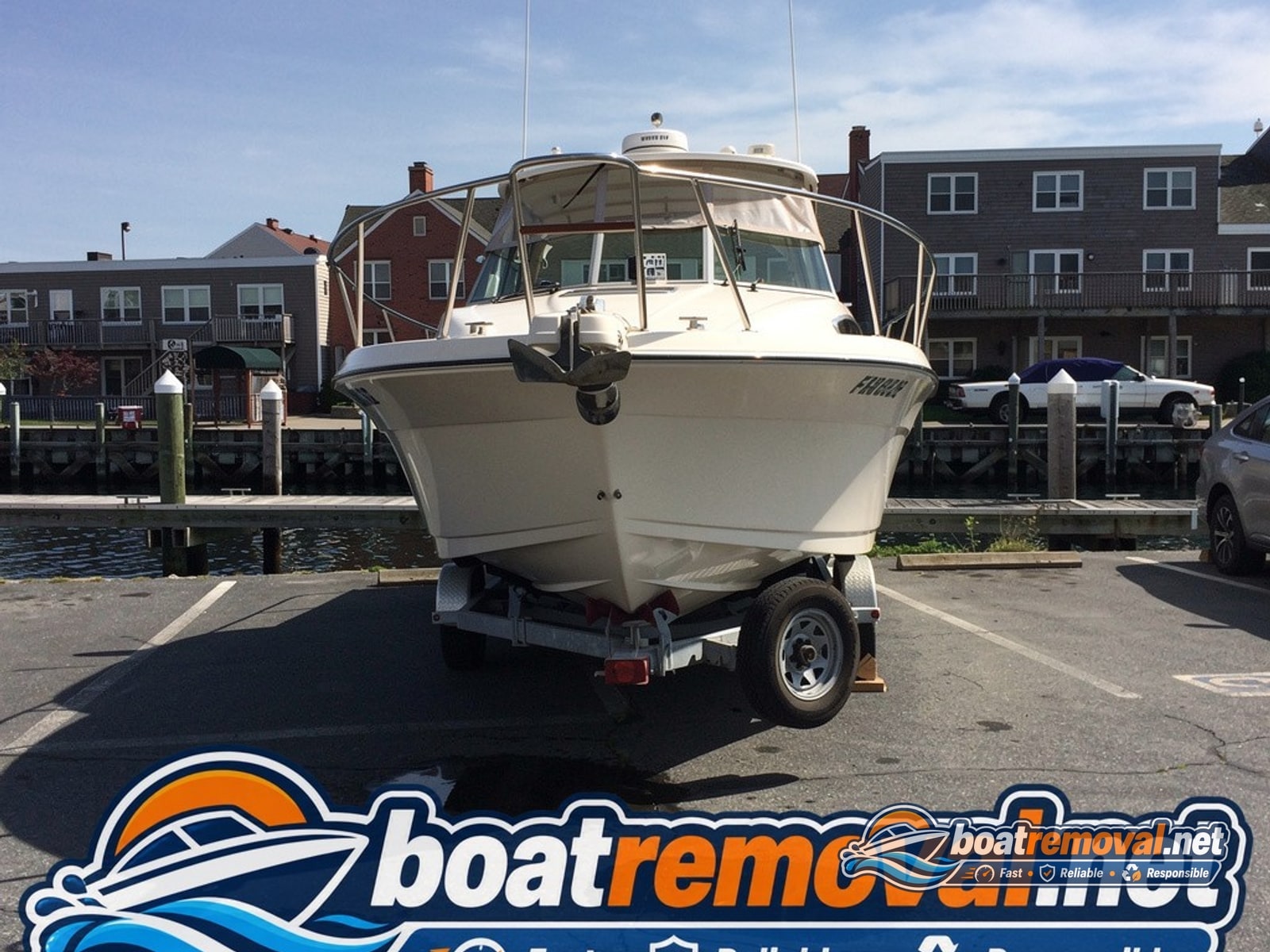 Portland, ME: 24-foot Formula cruiser loaded for removal Formula cruiser loaded onto a trailer after removal from a marina slip in Portland, Maine
