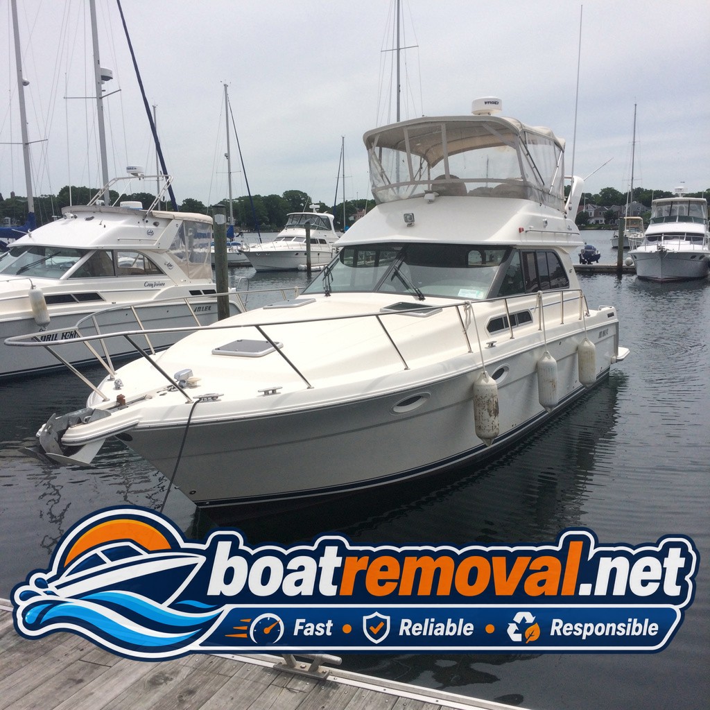 32-foot Carver motor yacht sitting in a marina slip in Portsmouth, New Hampshire before removal