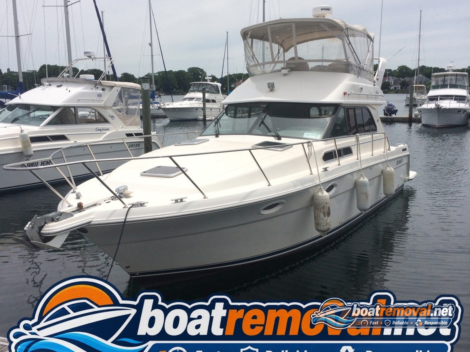 32-foot Carver motor yacht sitting in a marina slip in Portsmouth, New Hampshire before removal