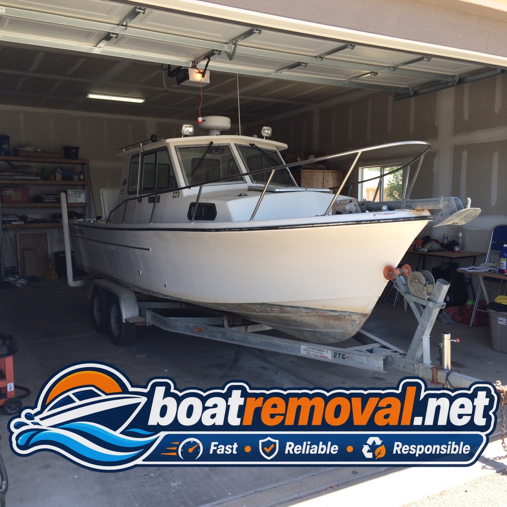 27-foot Trophy walkaround boat stored inside an oversized garage in Rio Rancho, New Mexico before removal