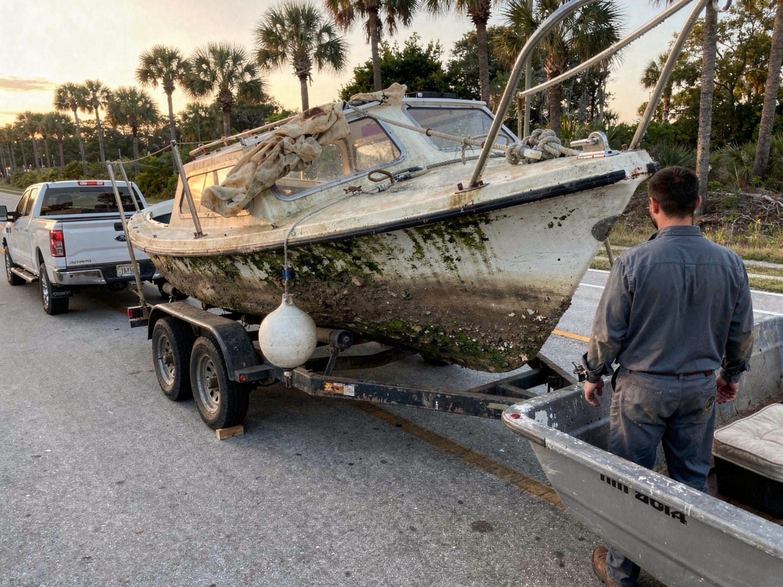 Sunken boat recovery in Royal Palm Beach, FL: hauled out on a trailer 22 ft Catalina 22 hauled out of Royal Palm Beach, FL on a trailer after the recovery