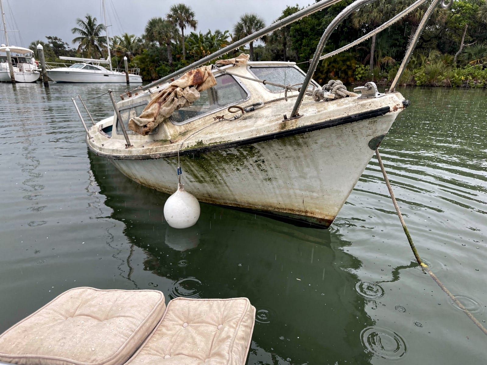 Sunken boat recovery in Royal Palm Beach, FL: before Sunken 22 ft Catalina 22 at its mooring in Royal Palm Beach, FL