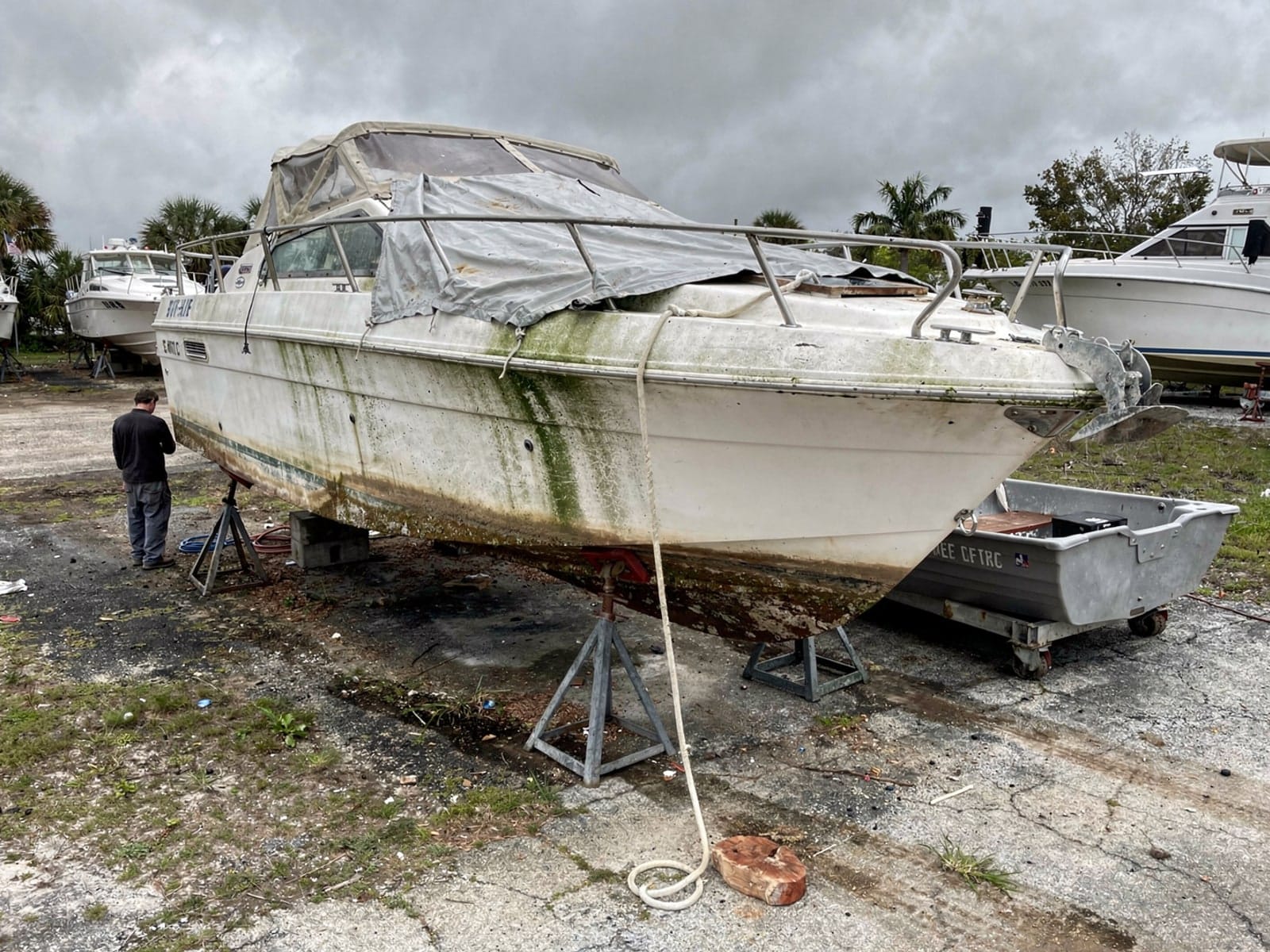 24 ft Bayliner 2455 Ciera from Ives Estates, FL on stands at a repair yard after the recovery