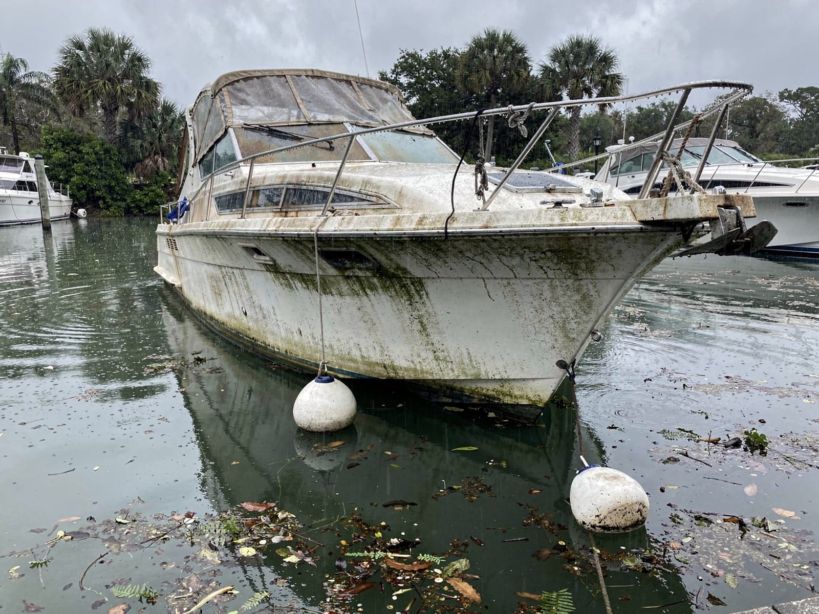 Sunken boat recovery in North Fort Myers, FL: before Sunken 34 ft Silverton 34 at its mooring in North Fort Myers, FL