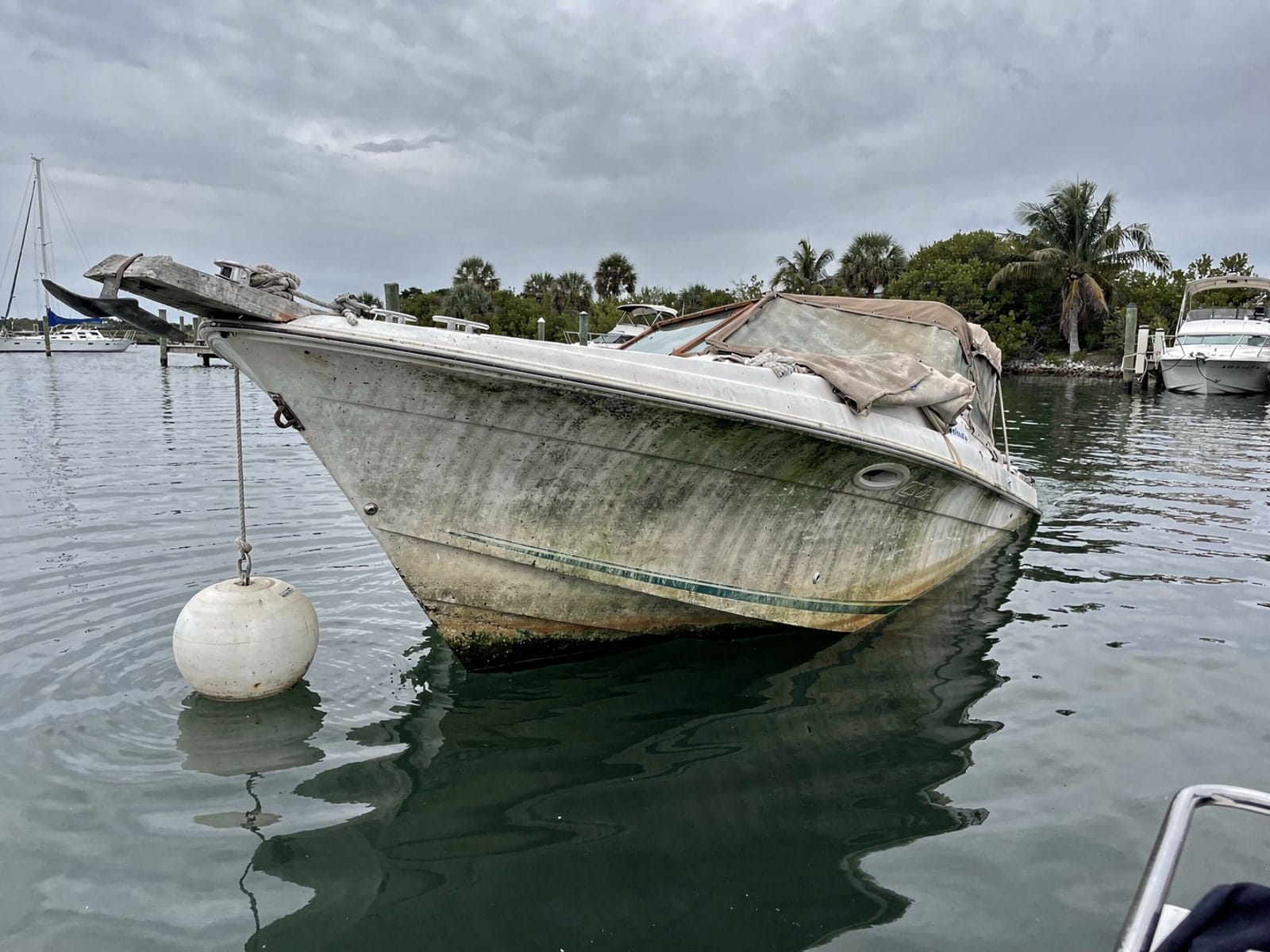 Sunken boat recovery in North Miami Beach, FL: before Sunken 24 ft Bayliner 2455 Ciera at its mooring in North Miami Beach, FL