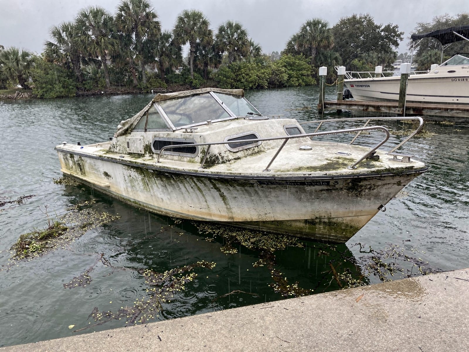 Sunken 21 ft Thompson 21 by a boat ramp in Valrico, FL