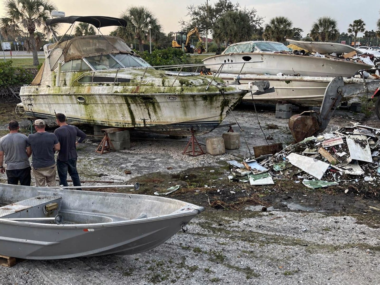 Sunken boat recovery in Sarasota, FL: at the recycling yard 28 ft Carver 28 from Sarasota, FL at the recycling yard after the recovery