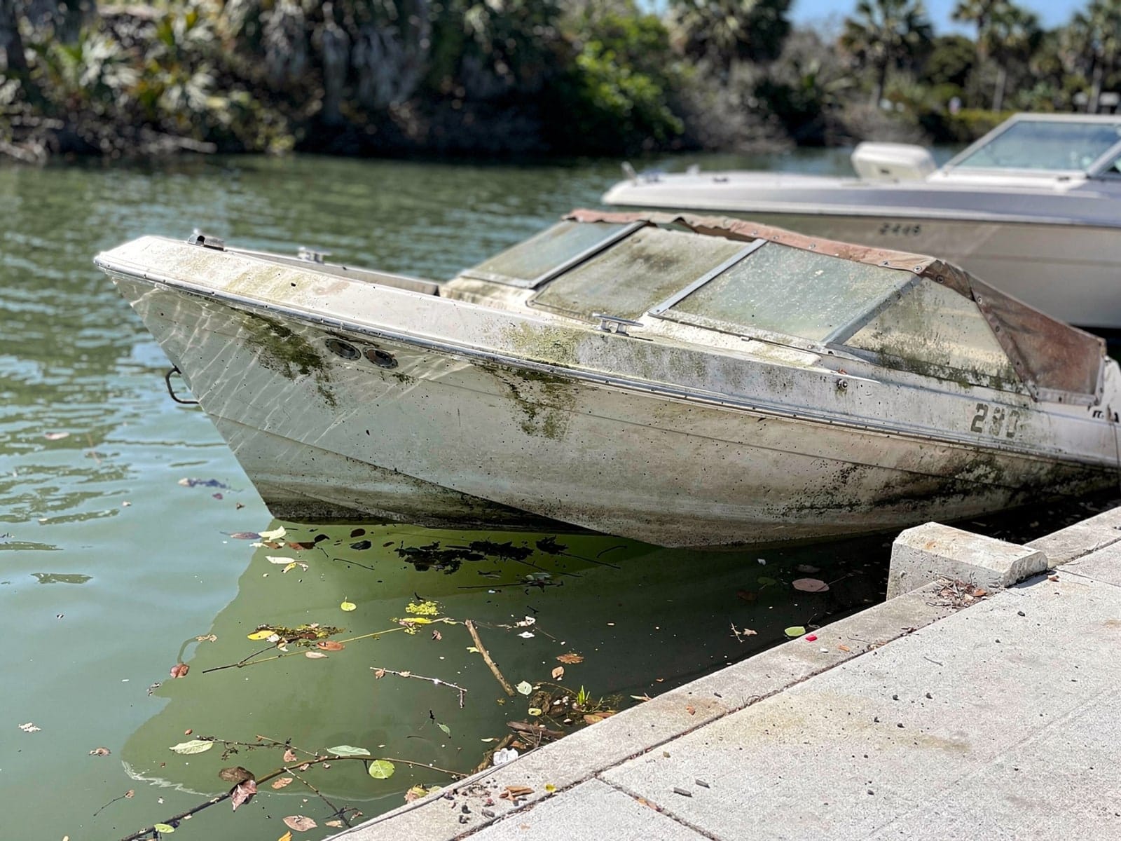 Sunken boat recovery in Sebring, FL: before Sunken 24 ft Formula 242 by a boat ramp in Sebring, FL