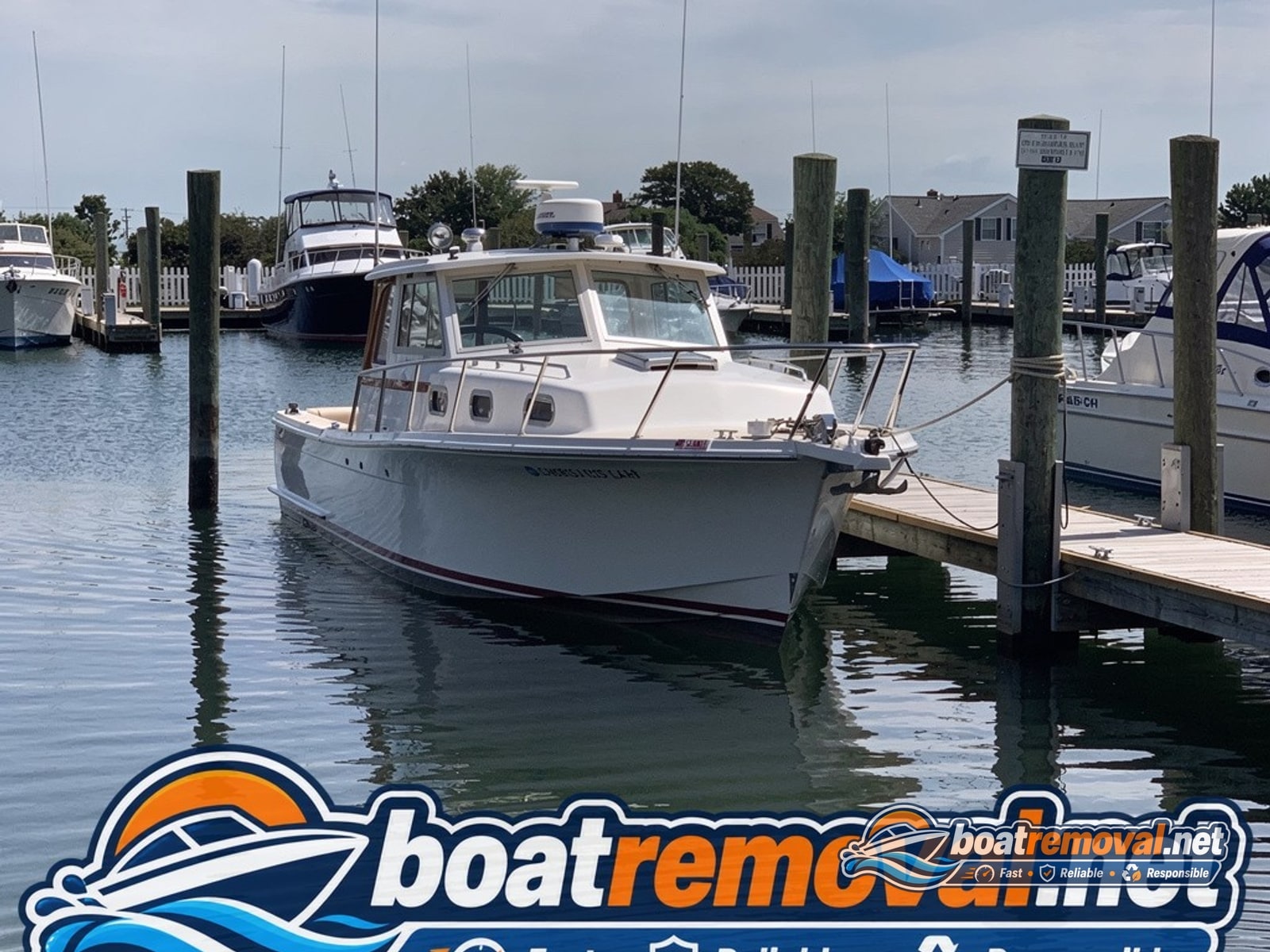 34-foot Chris-Craft motor yacht sitting in a marina slip in Somers Point, New Jersey before removal