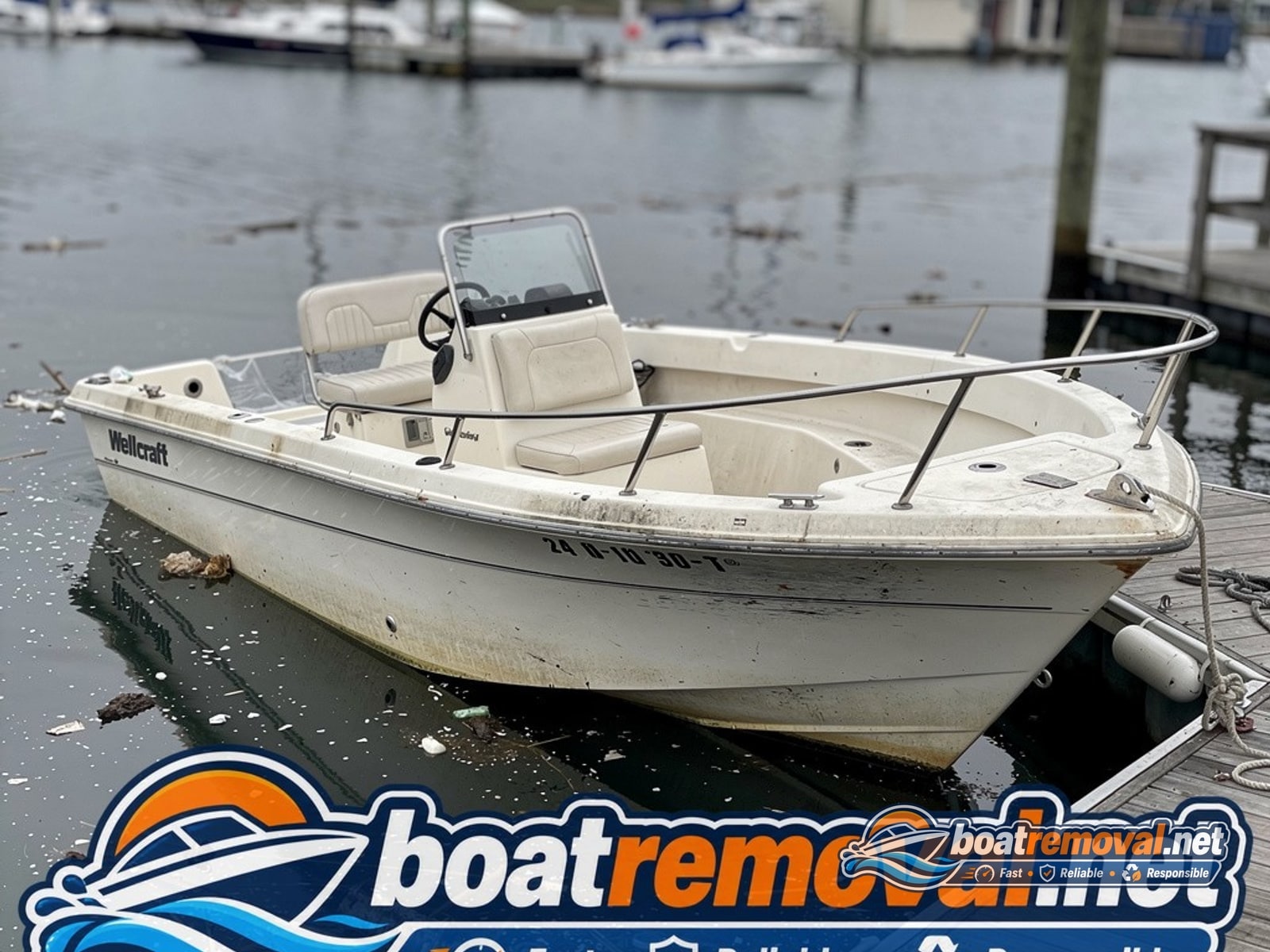 storm damaged boat removal Freeport NY, 24 ft Wellcraft center console half sunk