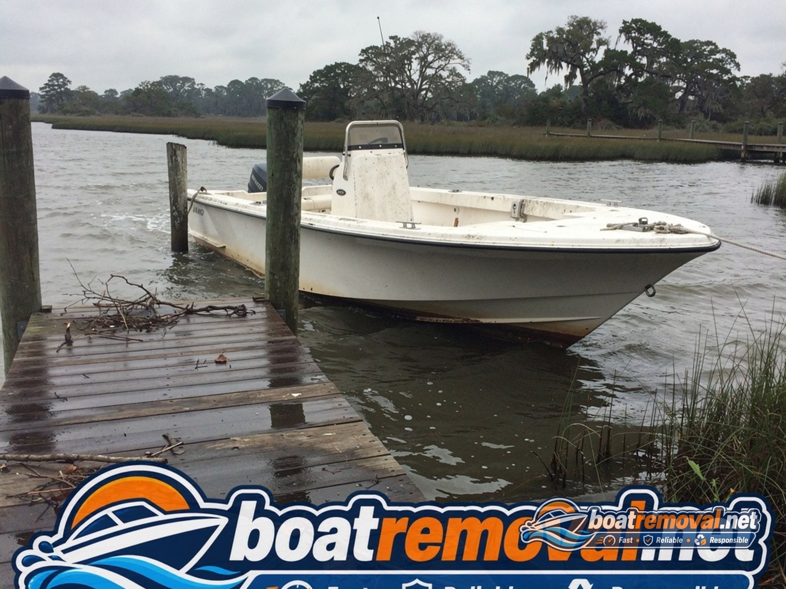20-foot Mako center console listing at a private dock after a storm near Midway, Georgia