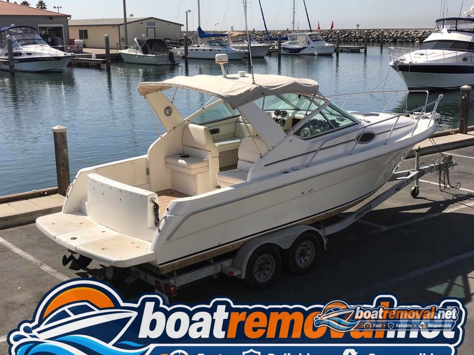 Port Hueneme, CA: 28-foot Carver cabin cruiser loaded for removal Carver cabin cruiser loaded onto a trailer after storm removal in Port Hueneme, California
