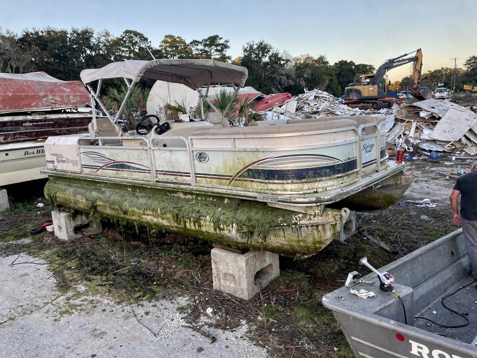 Sunken boat recovery in Eustis, FL: at the recycling yard 20 ft Sylvan Mirage 20 from Eustis, FL at the recycling yard after the recovery
