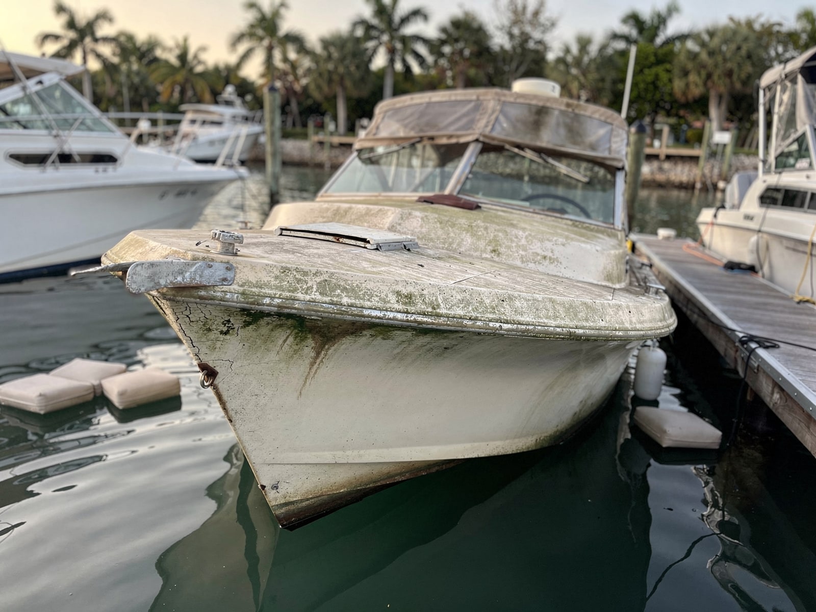 Sunken boat recovery in Panama City, FL: before Sunken 23 ft Chris-Craft Cavalier in a marina slip in Panama City, FL