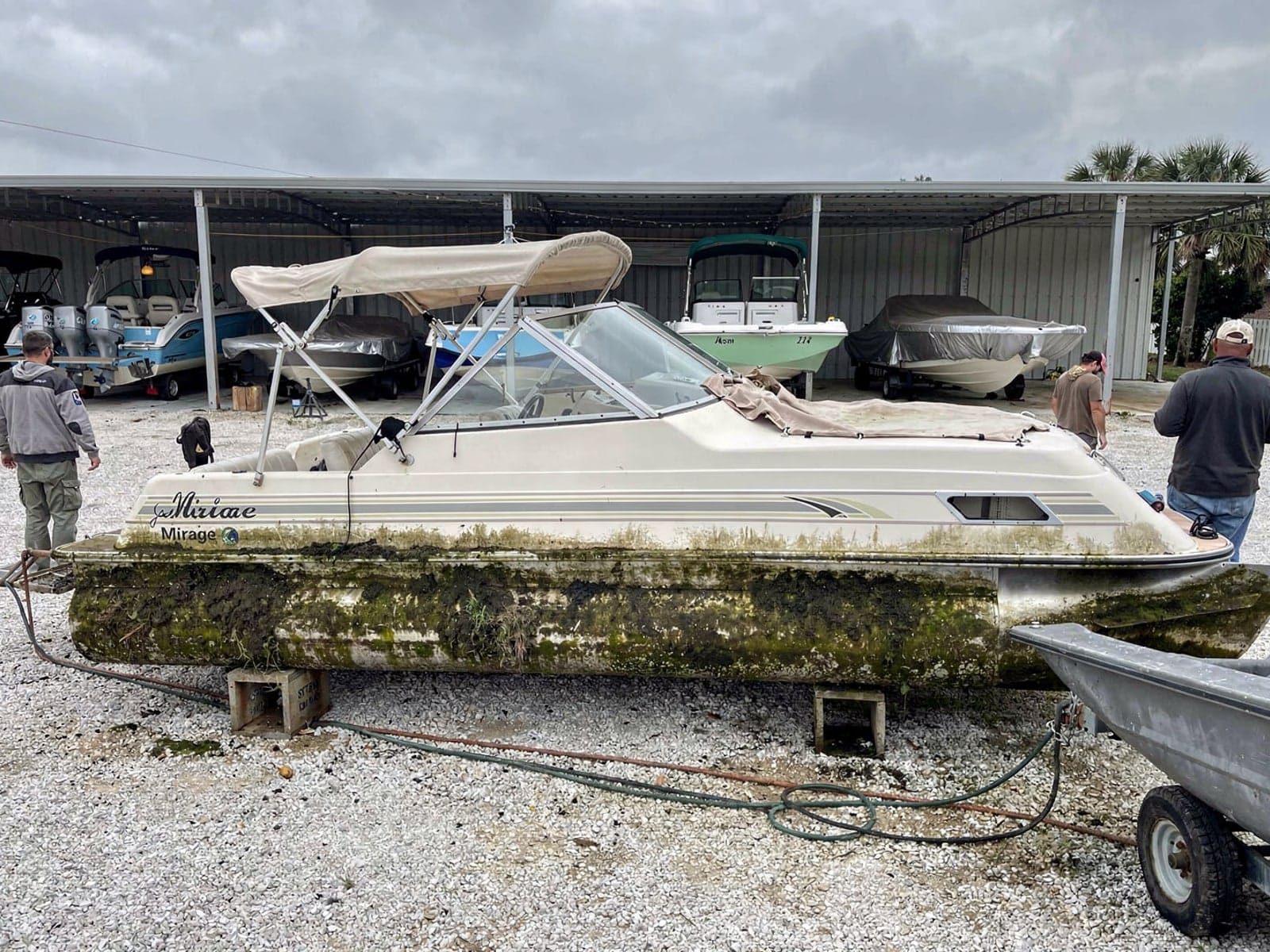 Sunken boat recovery in Pebble Creek, FL: at the repair yard 20 ft Sylvan Mirage 20 from Pebble Creek, FL on stands at a repair yard after the recovery