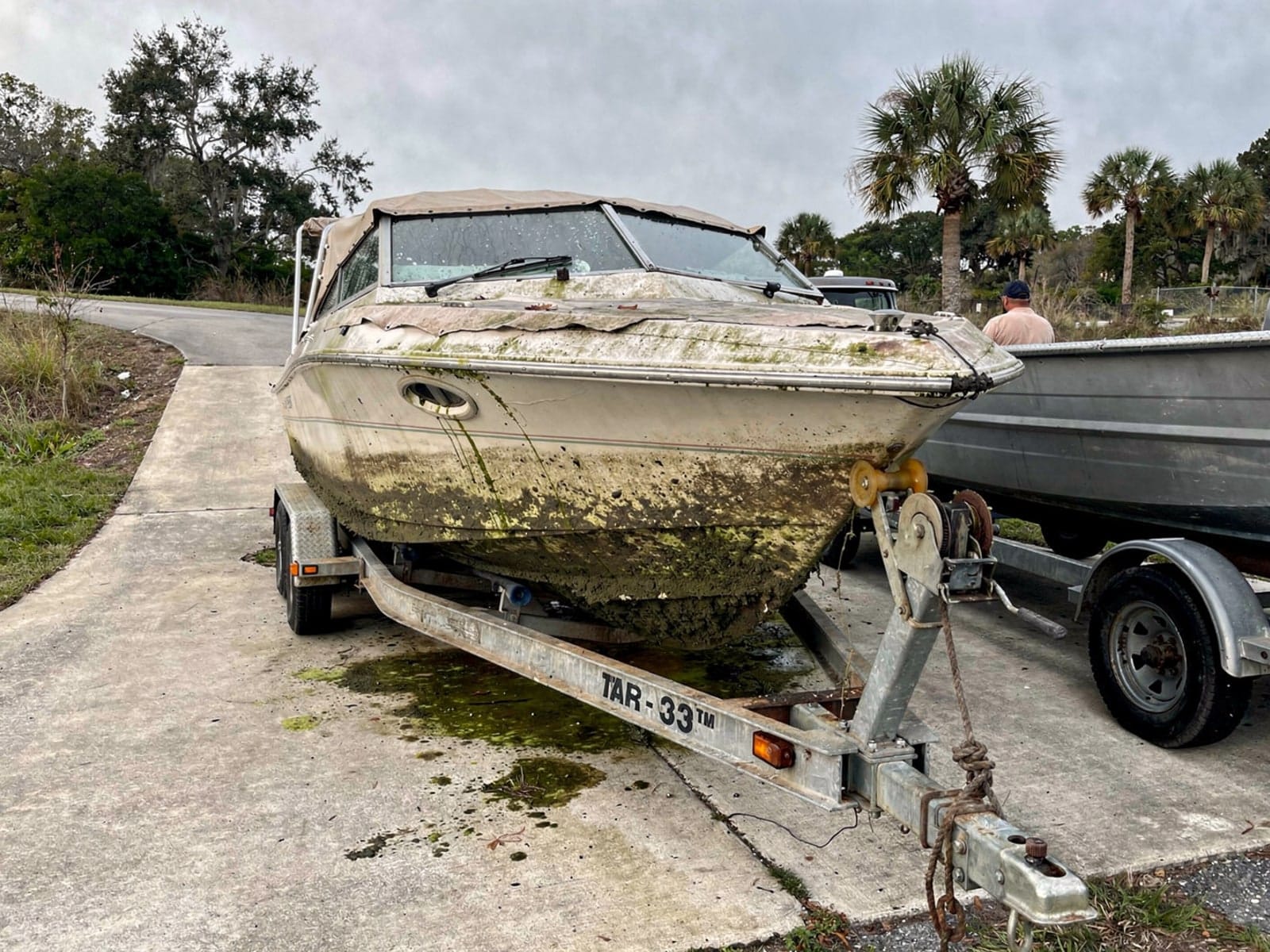 Sunken boat recovery in Tarpon Springs, FL: pulled out at the ramp 23 ft Rinker 232 pulled out on a trailer at a Tarpon Springs, FL boat ramp