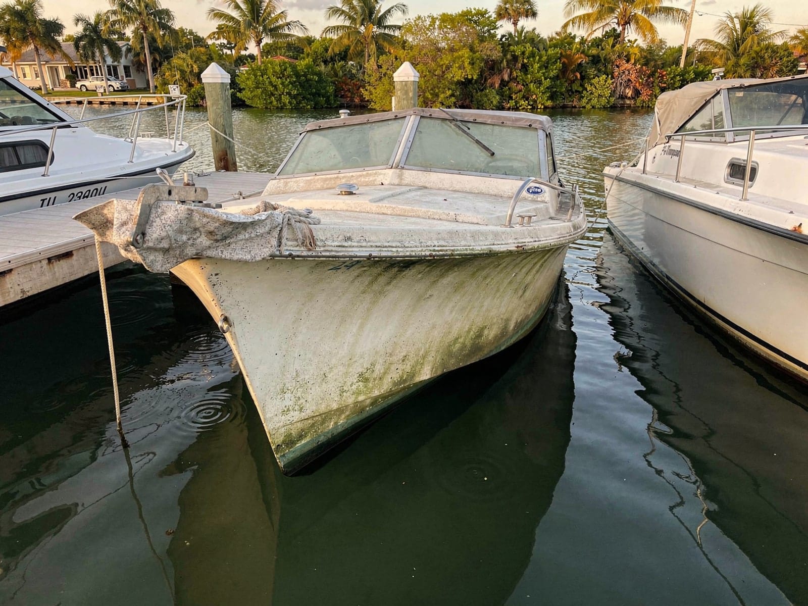 Sunken boat recovery in Gateway, FL: before Sunken 21 ft Thompson 21 in a marina slip in Gateway, FL