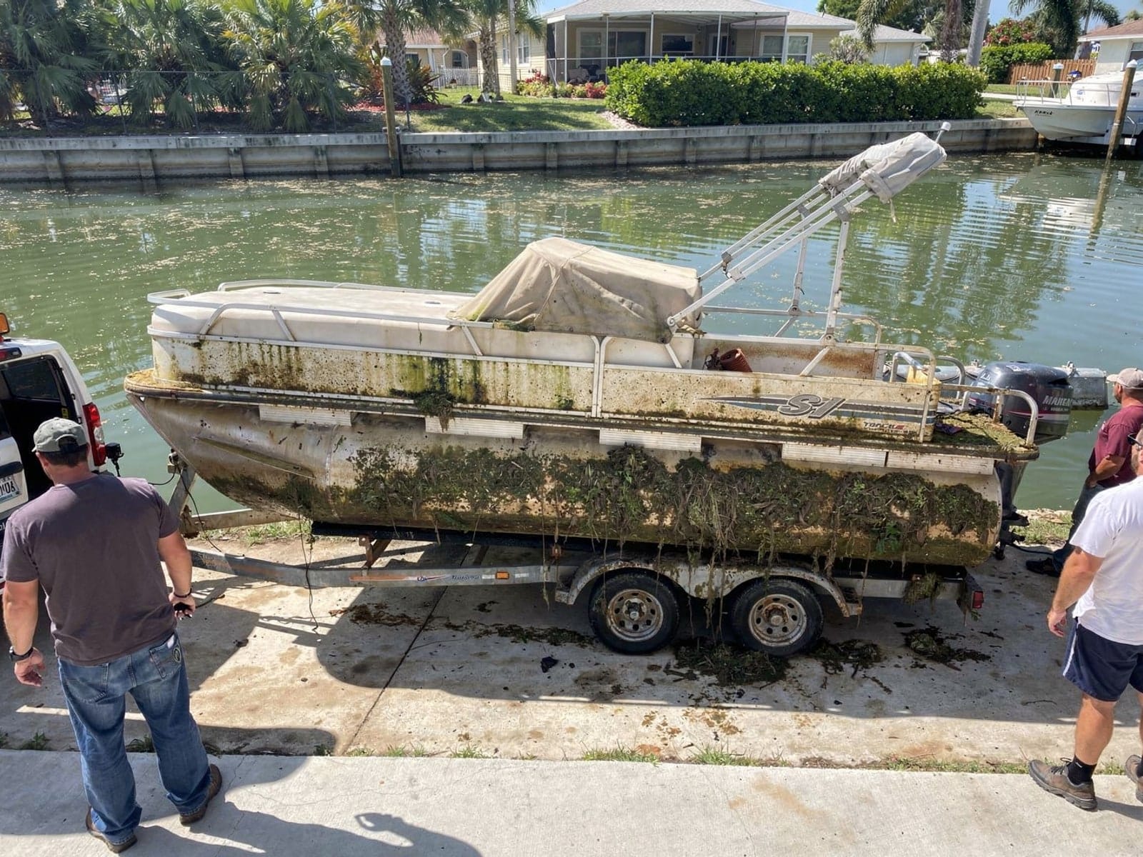22 ft Sun Tracker Party Barge 22 pulled out on a trailer at a Largo, FL boat ramp