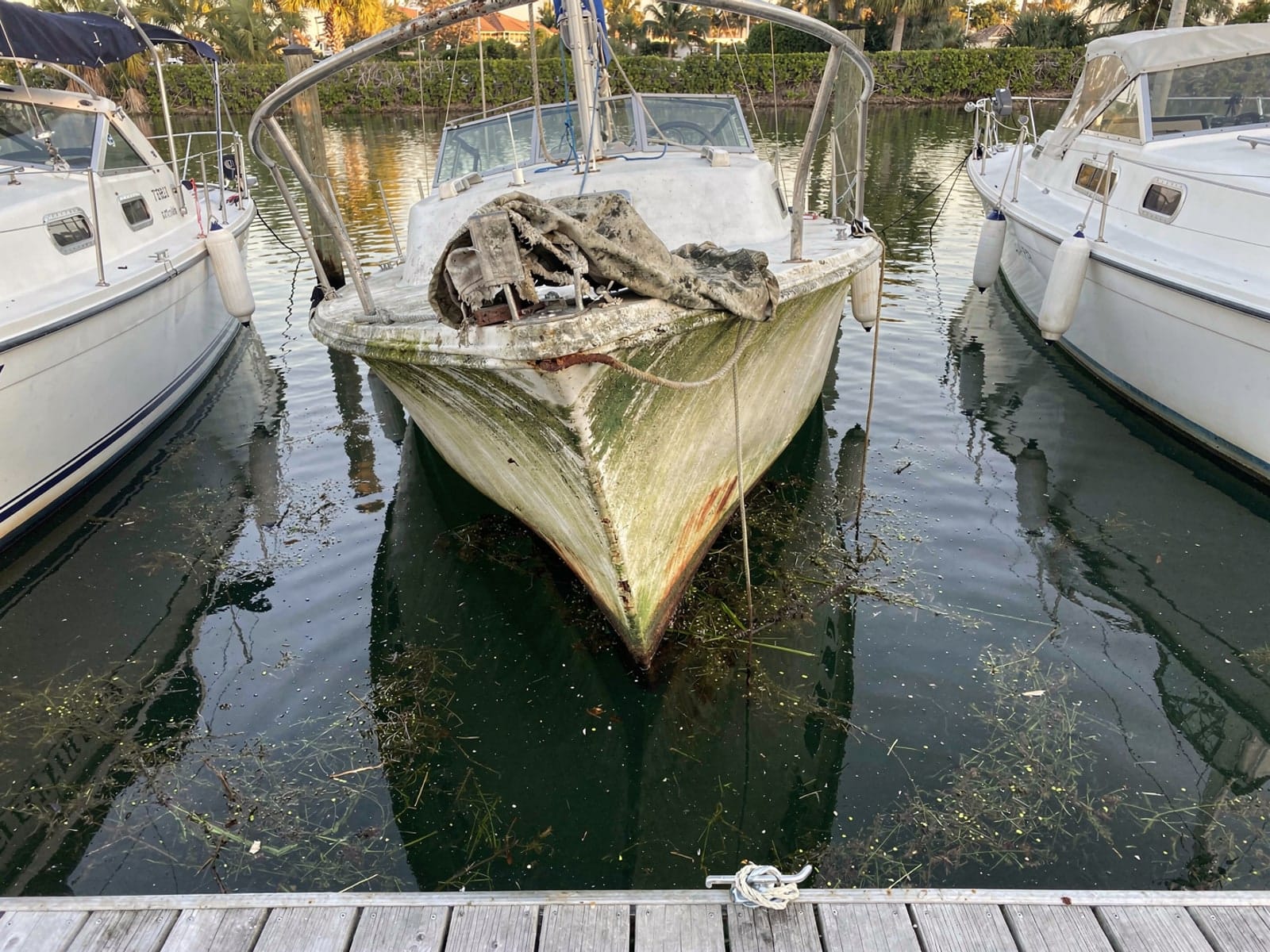 Sunken 25 ft O'Day 25 in a marina slip in West Vero Corridor, FL