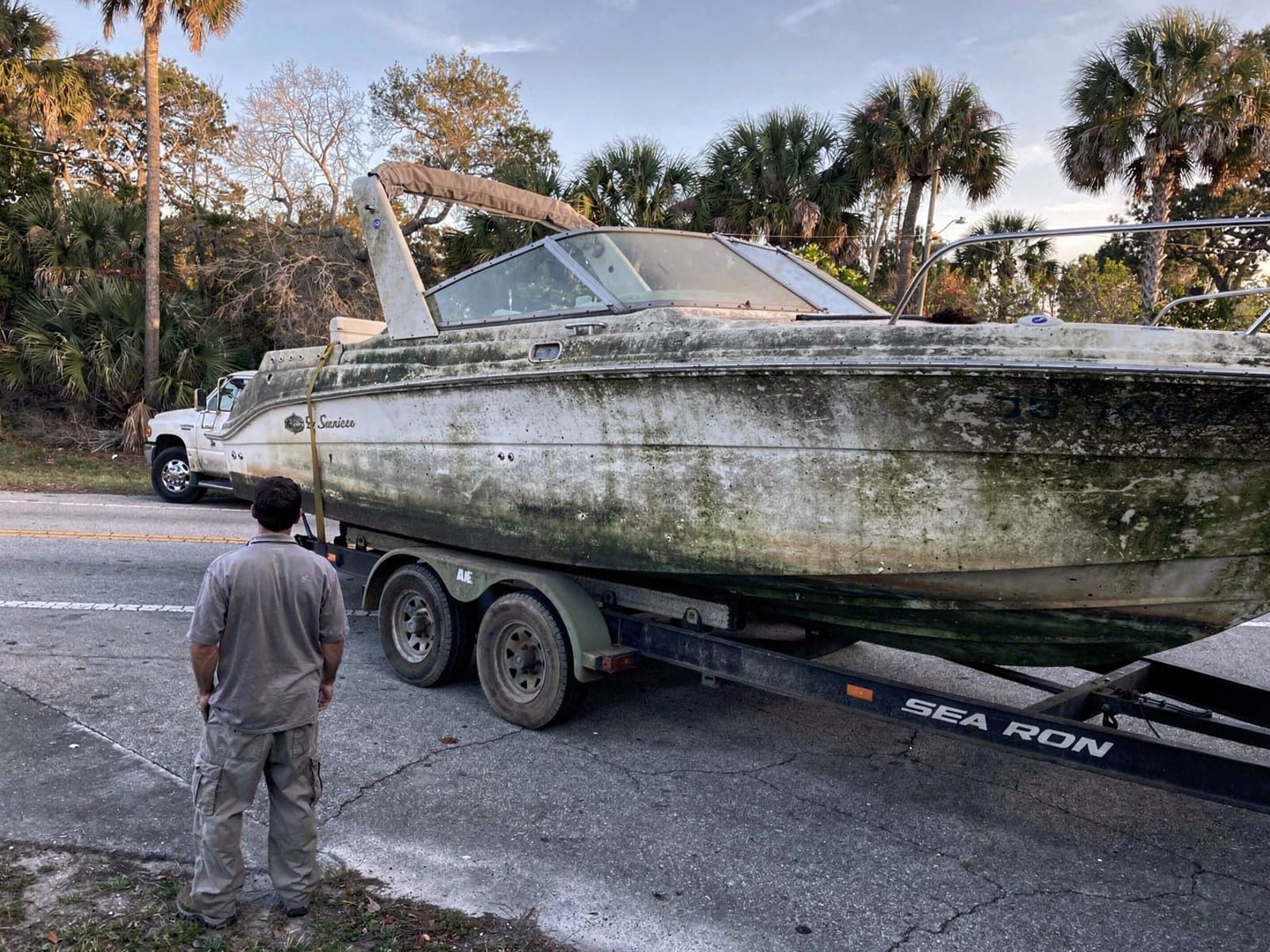 Sunken boat recovery in Bellair Meadowbrook Terrace, FL: hauled out on a trailer 26 ft Sea Ray 268 Sundancer hauled out of Bellair Meadowbrook Terrace, FL on a trailer after the recovery