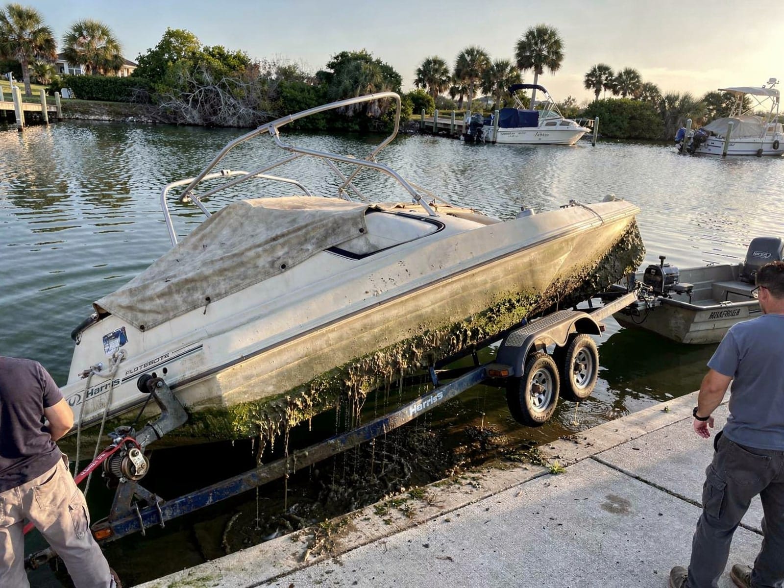 24 ft Harris FloteBote 24 pulled out on a trailer at a Key West, FL boat ramp