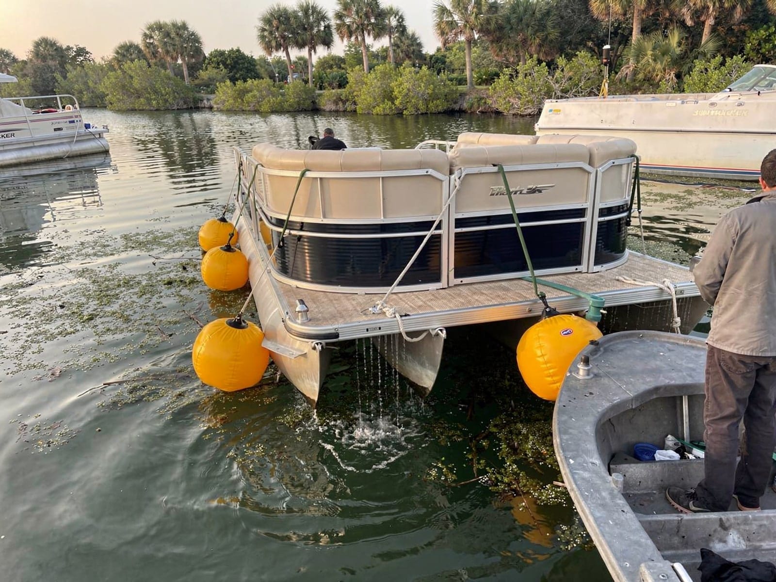 22 ft Sun Tracker Party Barge 22 raised by lift bags in Leisure City, FL