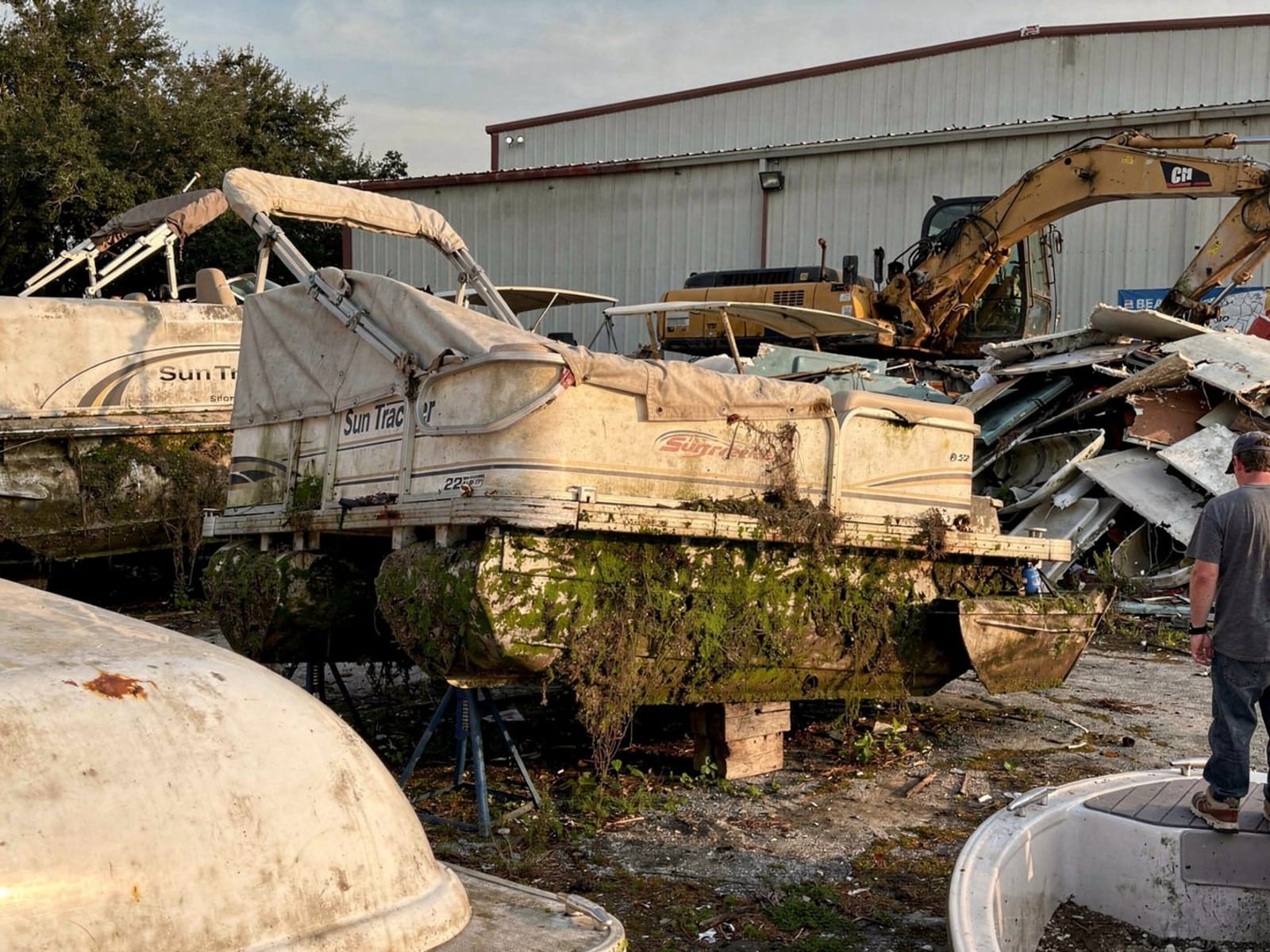 22 ft Sun Tracker Party Barge 22 from Ruskin, FL at the recycling yard after the recovery