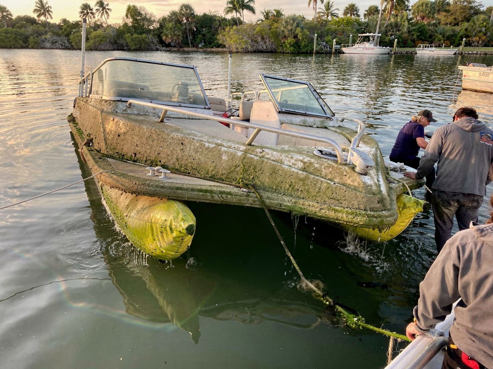Sunken boat recovery in Sanford, FL: raised with lift bags 22 ft Sun Tracker Party Barge 22 raised by lift bags in Sanford, FL