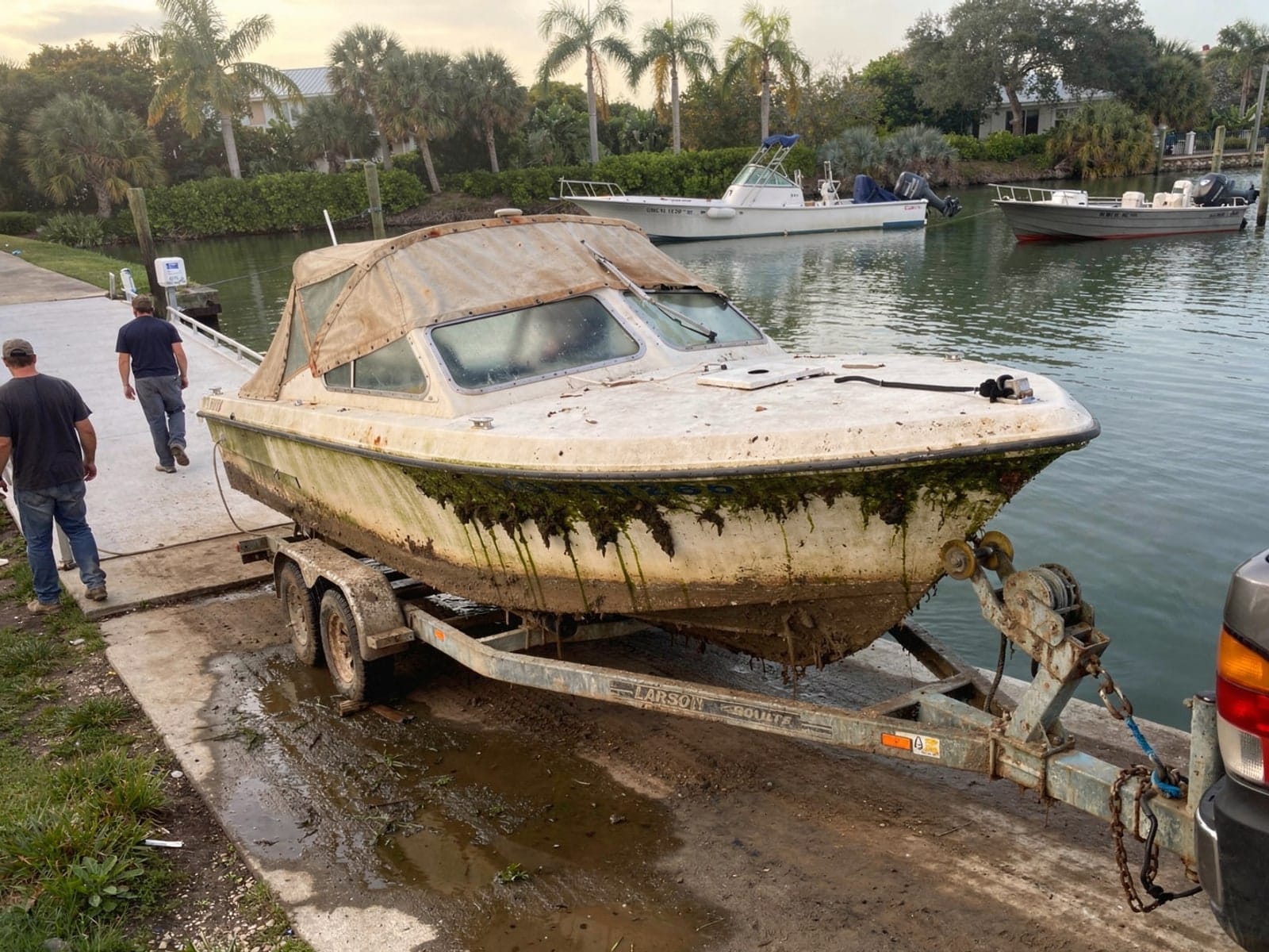 Sunken boat recovery in Tamiami, FL: pulled out at the ramp 22 ft Larson 220 pulled out on a trailer at a Tamiami, FL boat ramp