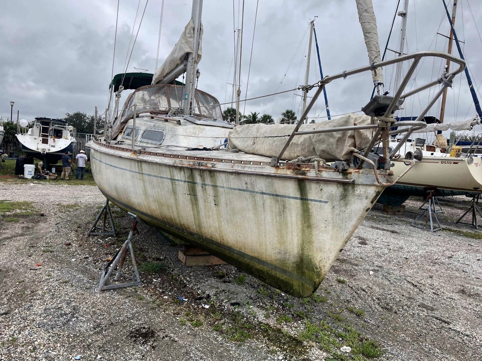 Sunken boat recovery in Alafaya, FL: at the repair yard 27 ft Catalina 27 from Alafaya, FL on stands at a repair yard after the recovery