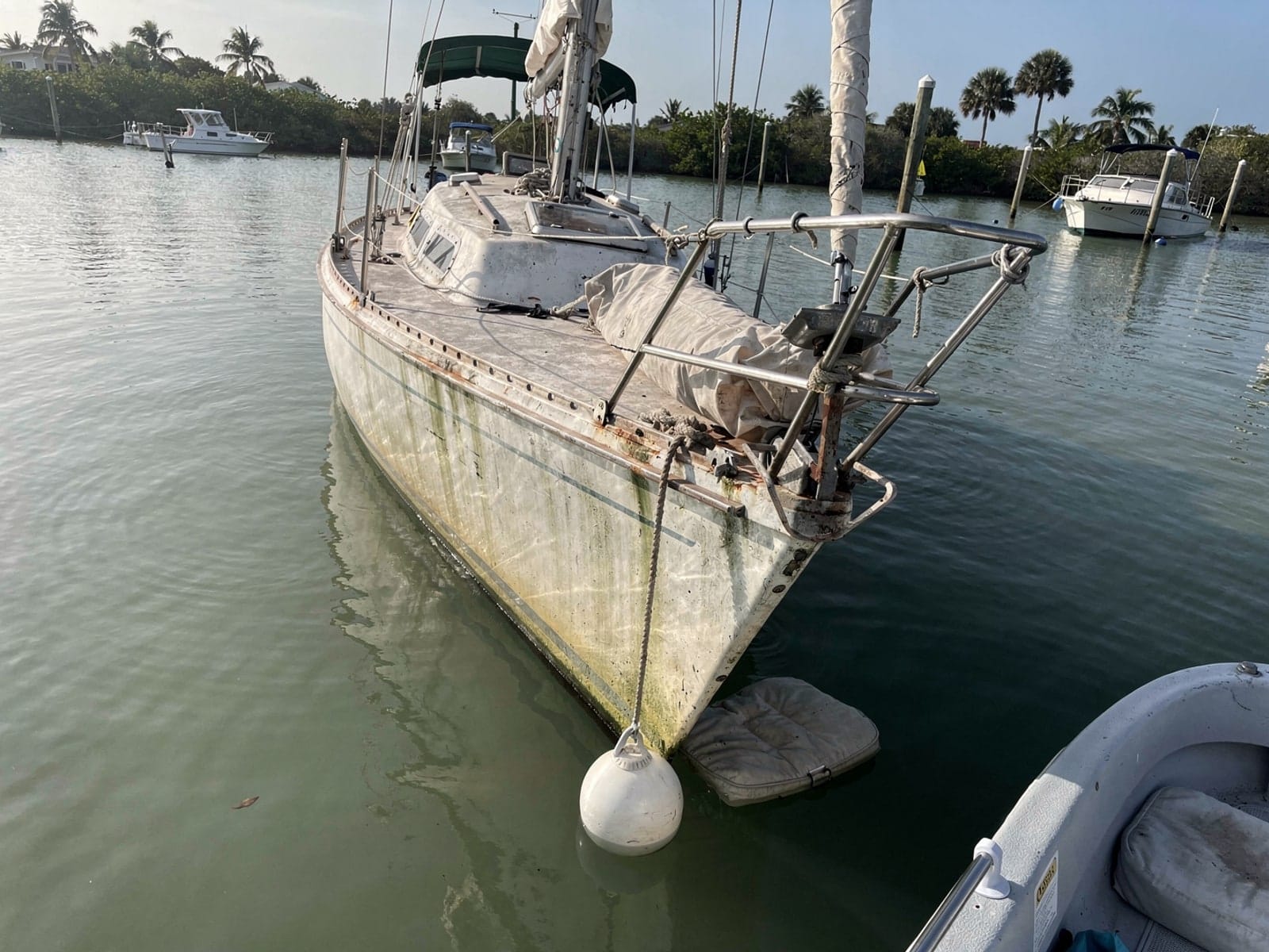 Sunken boat recovery in Alafaya, FL: before Sunken 27 ft Catalina 27 at its mooring in Alafaya, FL