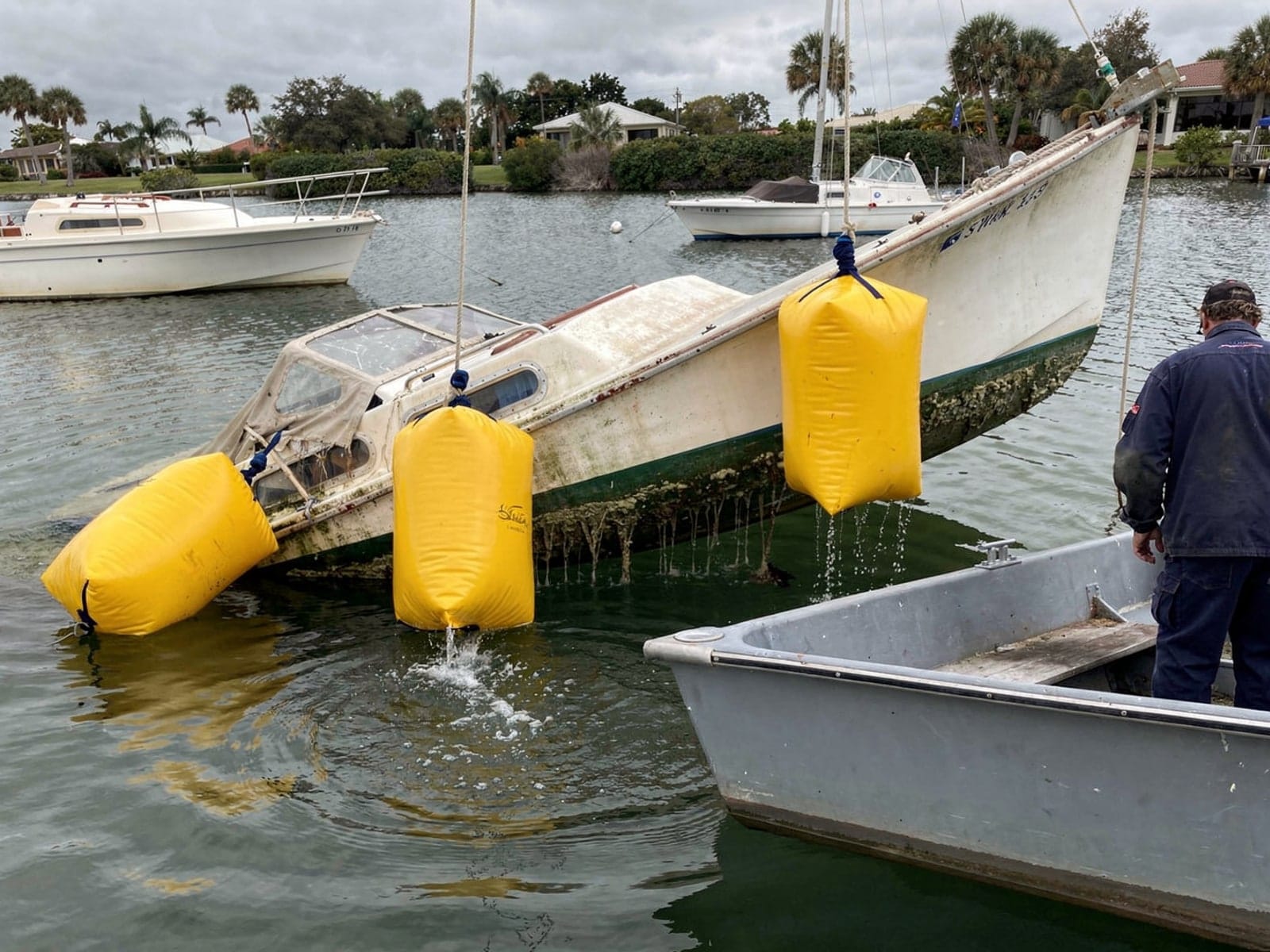 Sunken boat recovery in Carrollwood, FL: raised with lift bags 27 ft Ericson 27 raised by lift bags in Carrollwood, FL