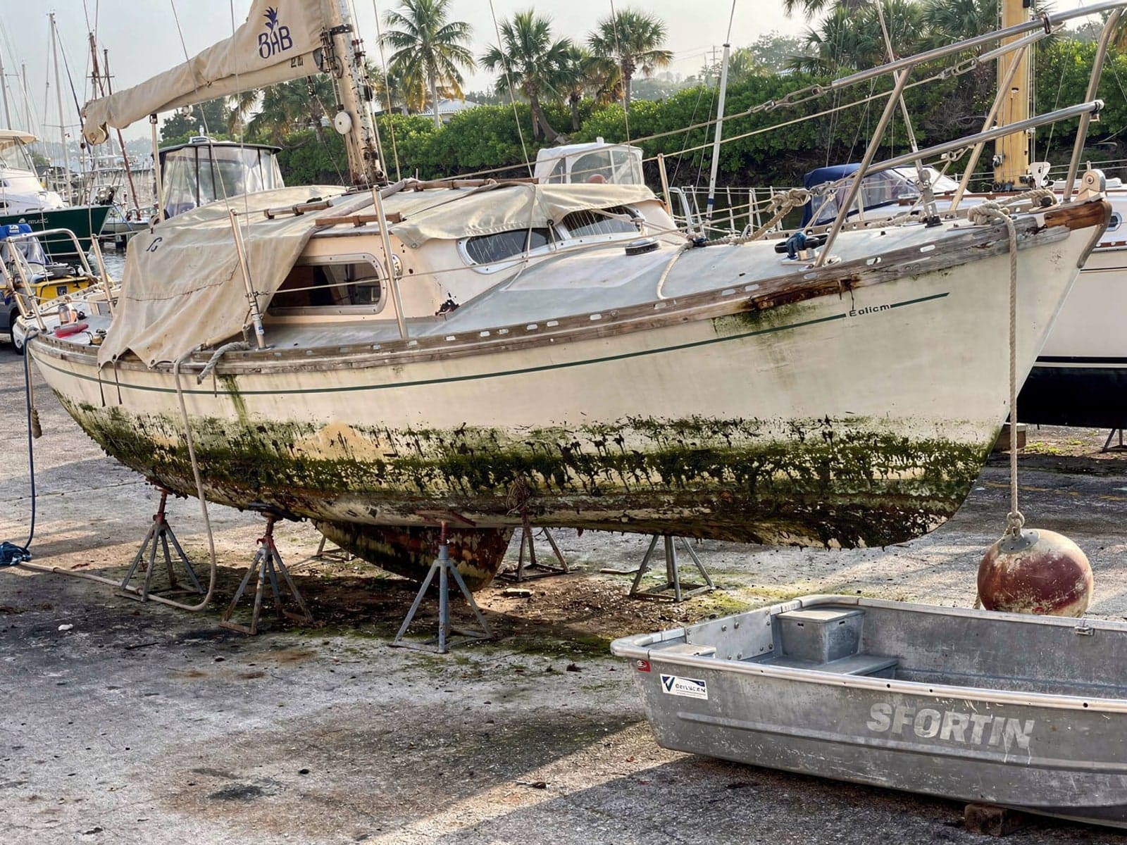 26 ft Pearson 26 from Kendall, FL on stands at a repair yard after the recovery