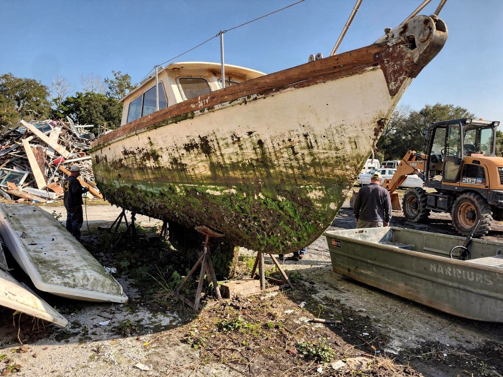 Sunken boat recovery in Miami Gardens, FL: at the recycling yard 26 ft Pearson 26 from Miami Gardens, FL at the recycling yard after the recovery