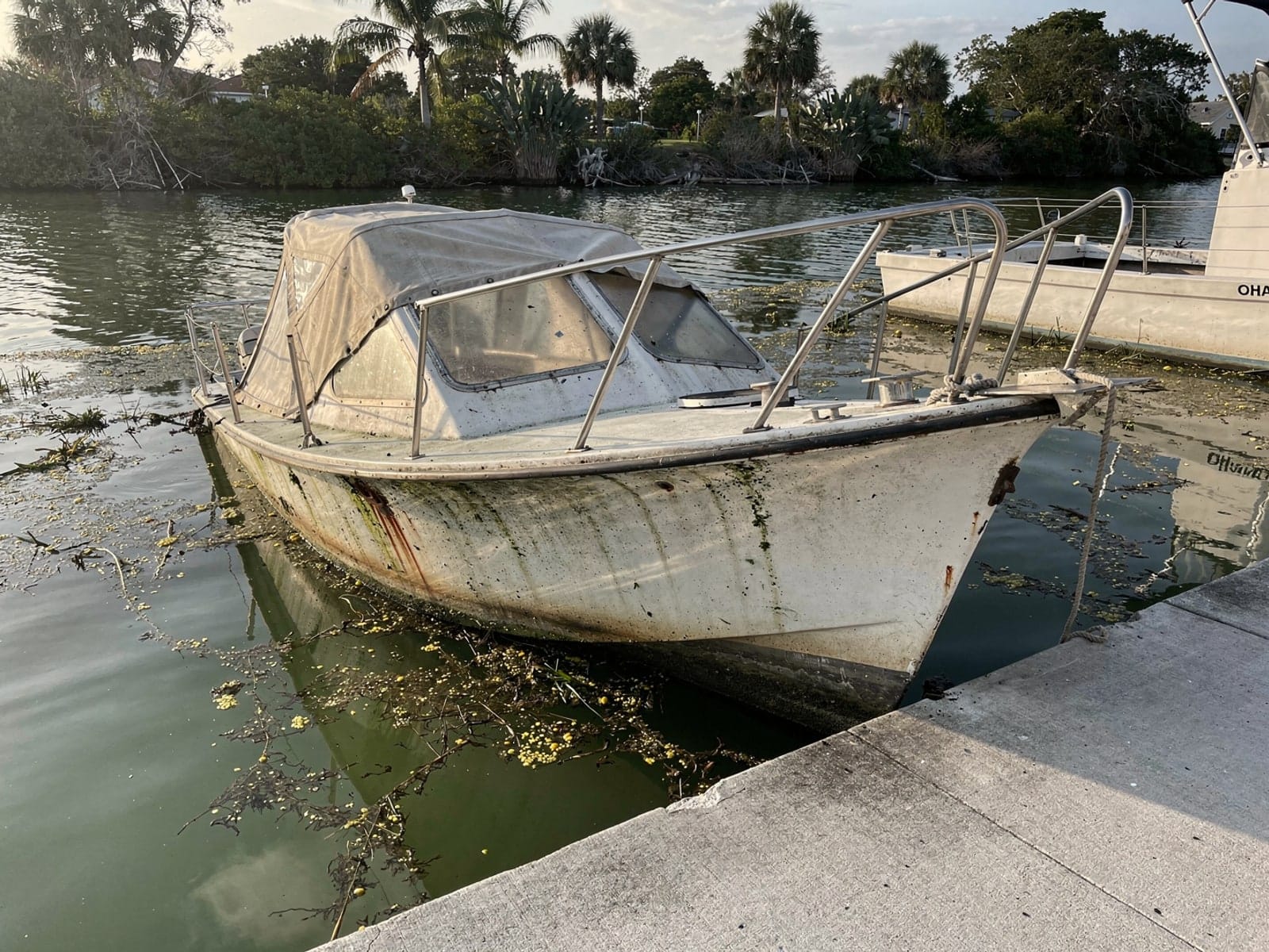 Sunken boat recovery in North Port, FL: before Sunken 25 ft O'Day 25 by a boat ramp in North Port, FL