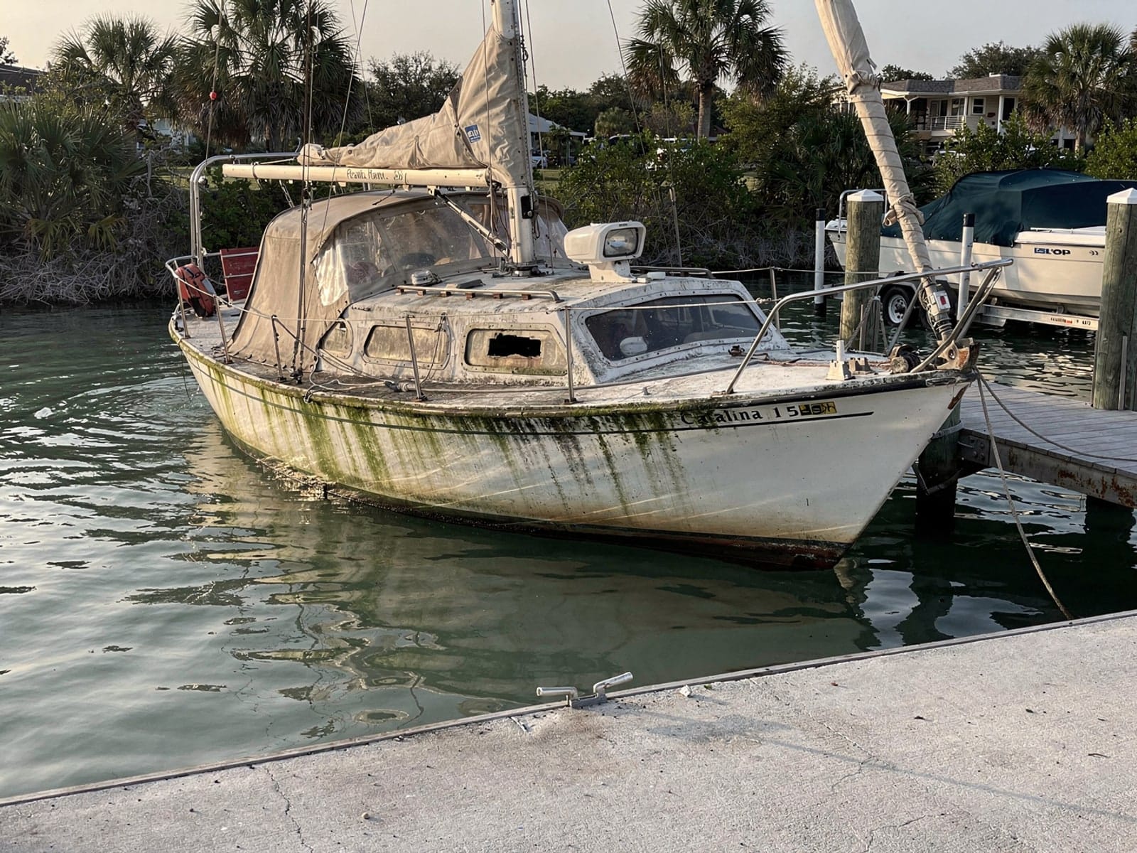 Sunken boat recovery in Port Orange, FL: before Sunken 27 ft Catalina 27 by a boat ramp in Port Orange, FL
