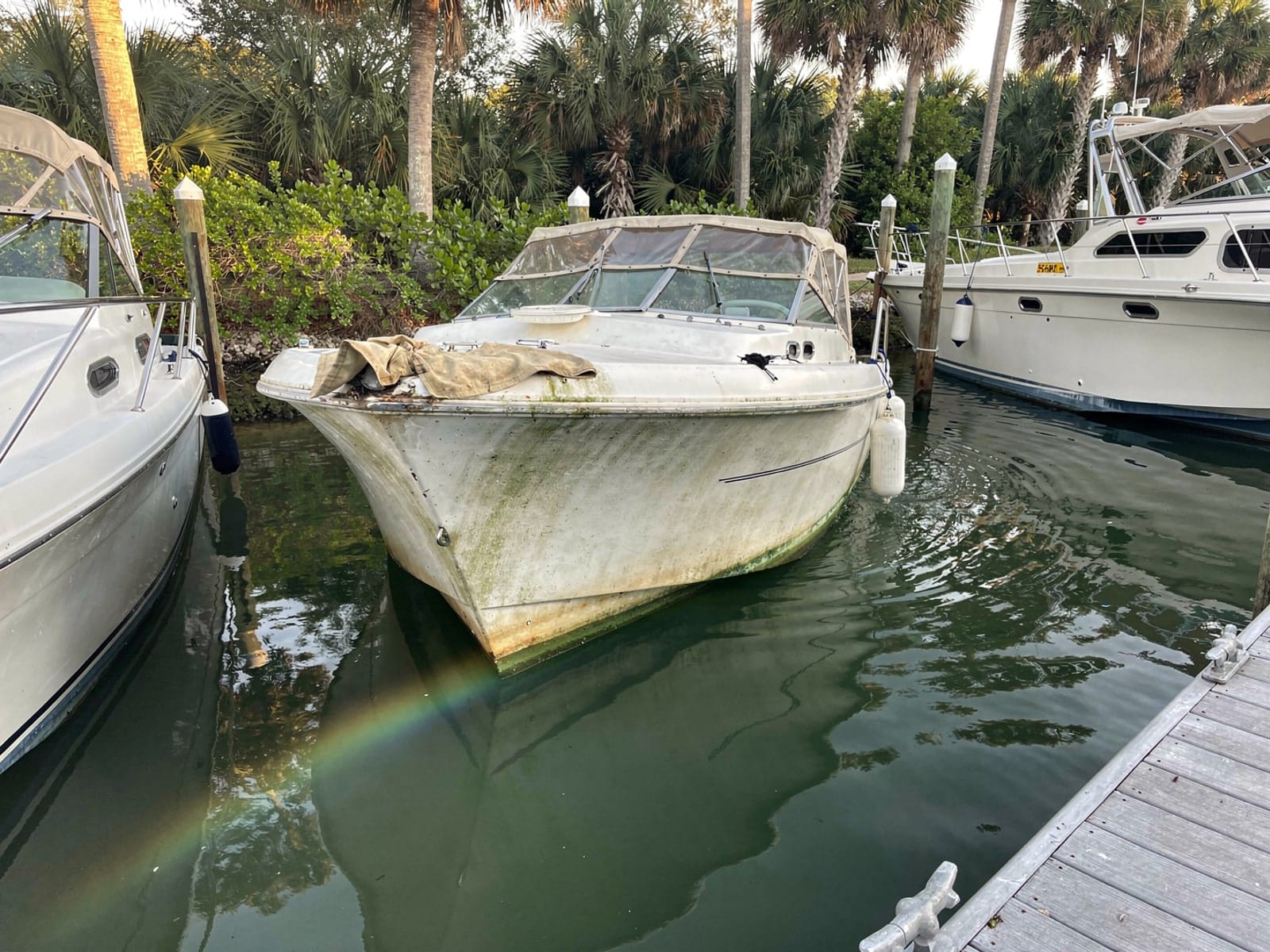 Sunken boat recovery in Sebastian, FL: before Sunken 23 ft Chris-Craft Cavalier in a marina slip in Sebastian, FL