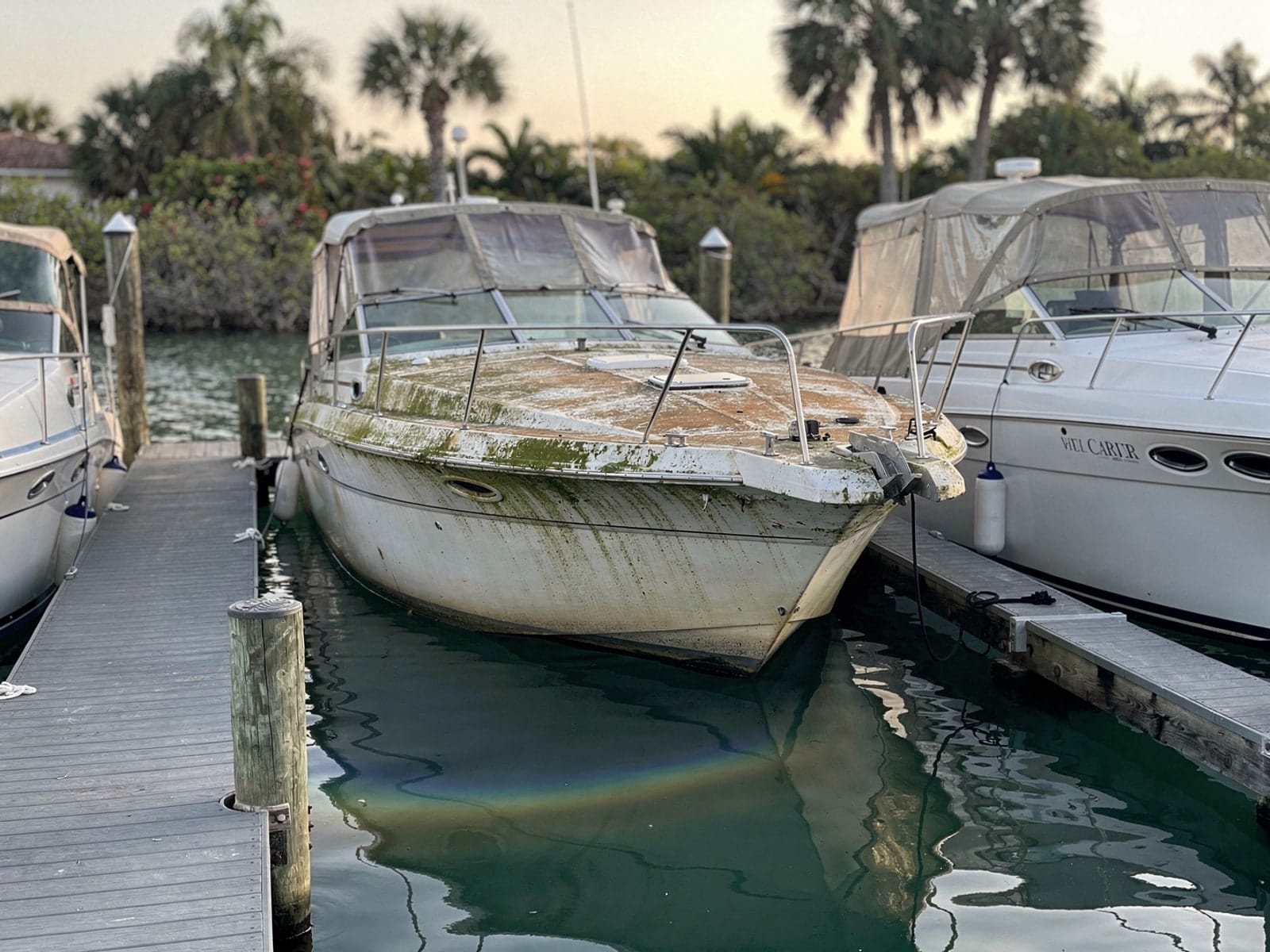 Sunken 28 ft Carver 28 in a marina slip in Wellington, FL