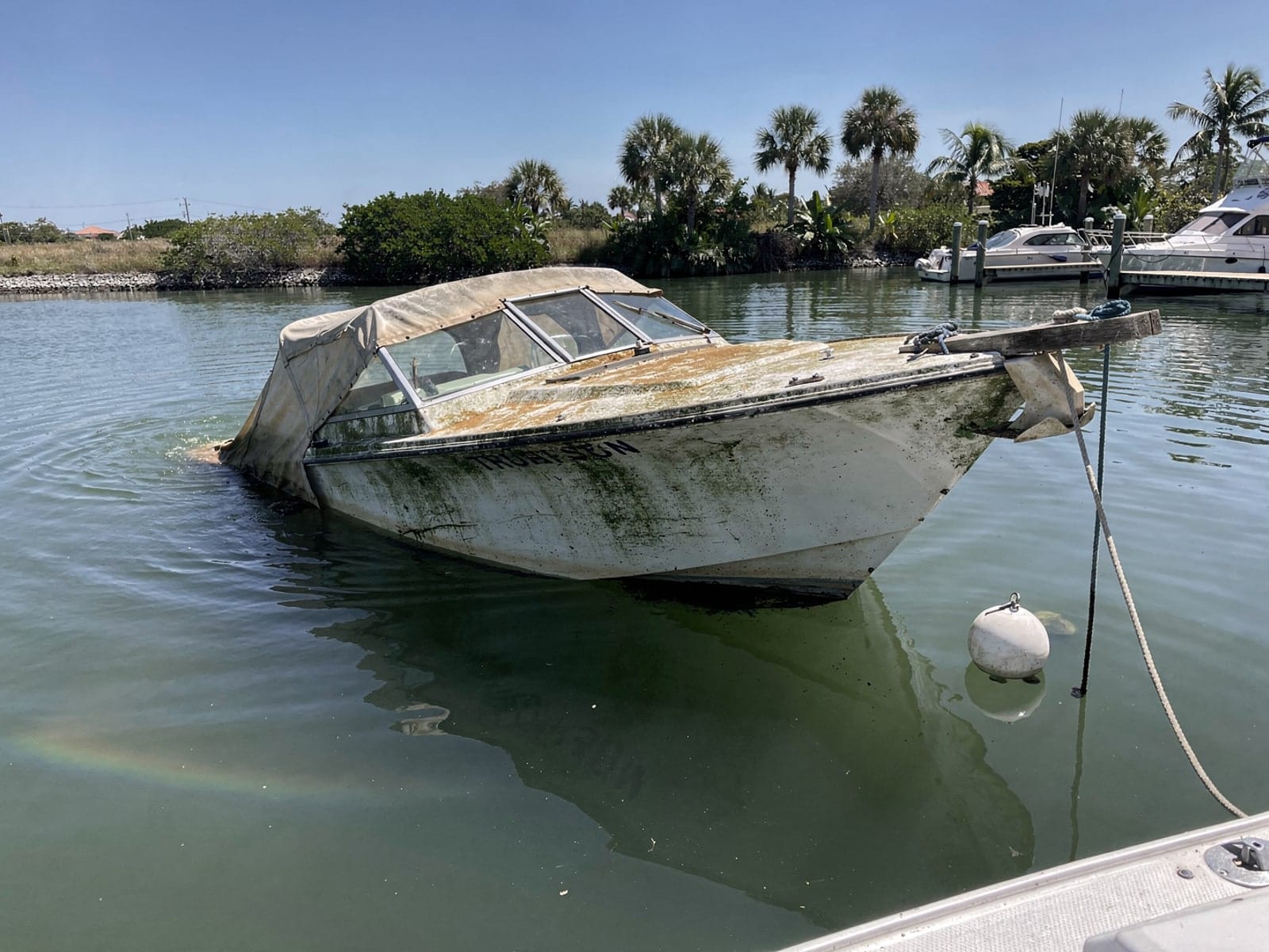 Sunken boat recovery in Haines City, FL: before Sunken 21 ft Thompson 21 at its mooring in Haines City, FL